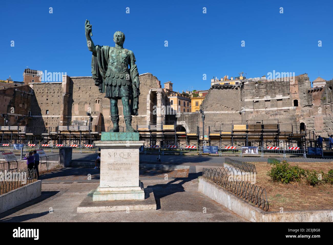 Roman Emperor Nerva (Marcus Cocceius Nerva) bronze statue at Via dei Fori Imperiali in Rome, Italy, Forum of Augustus in the background. Stock Photo