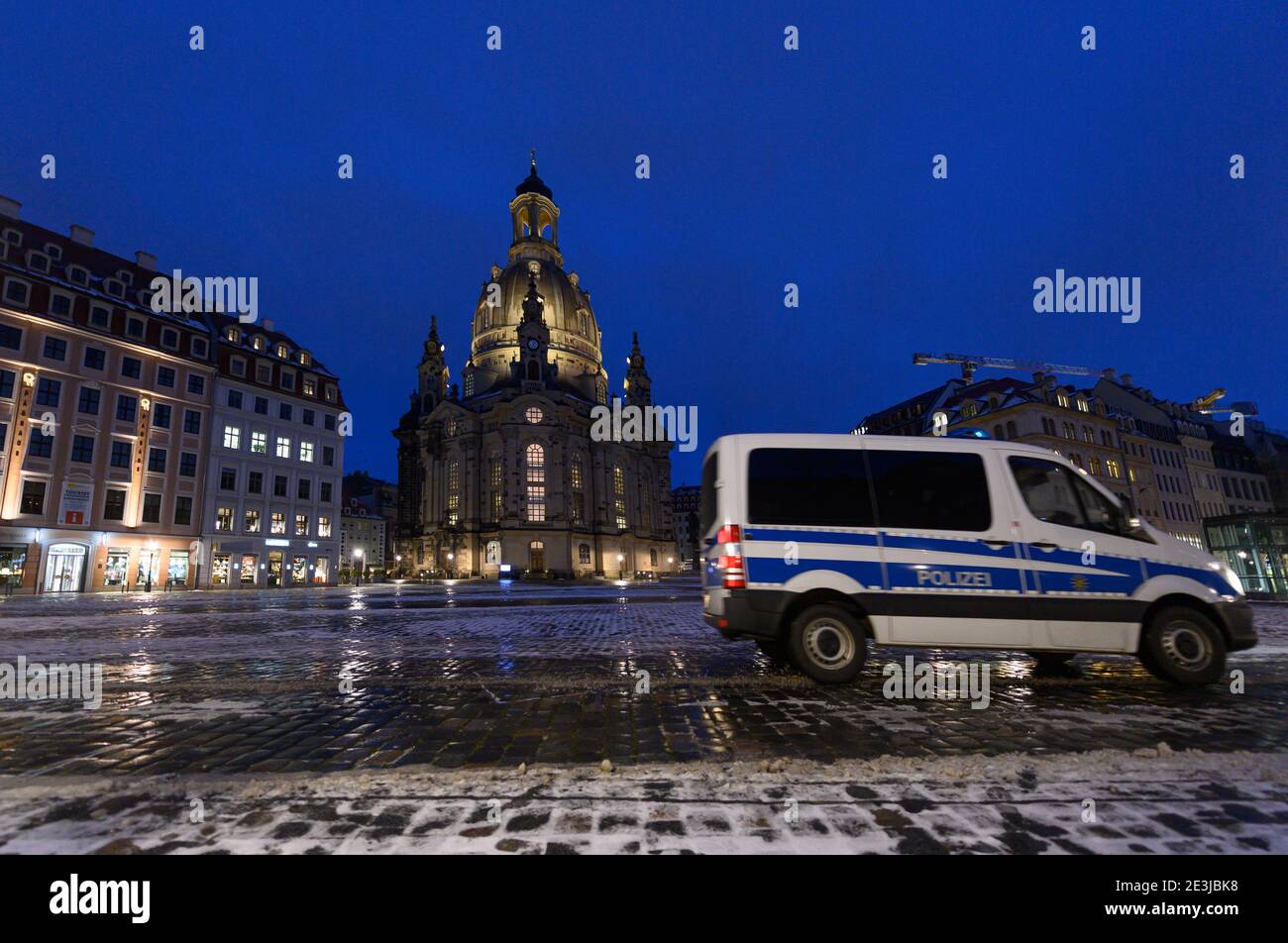 Dresden, Germany. 18th Jan, 2021. A police car drives across the Neumarkt in front of the Frauenkirche in the evening. Credit: Robert Michael/dpa-Zentralbild/dpa/Alamy Live News Stock Photo