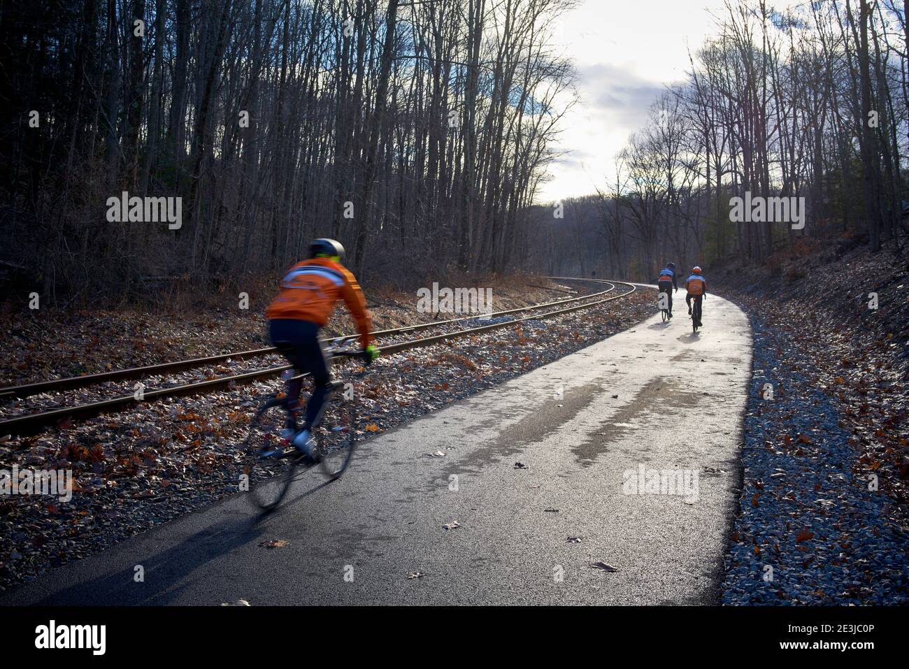 Bikers on the Empire State Trail bike path next to railroad tracks in the Hudson Valley, New York State. Stock Photo