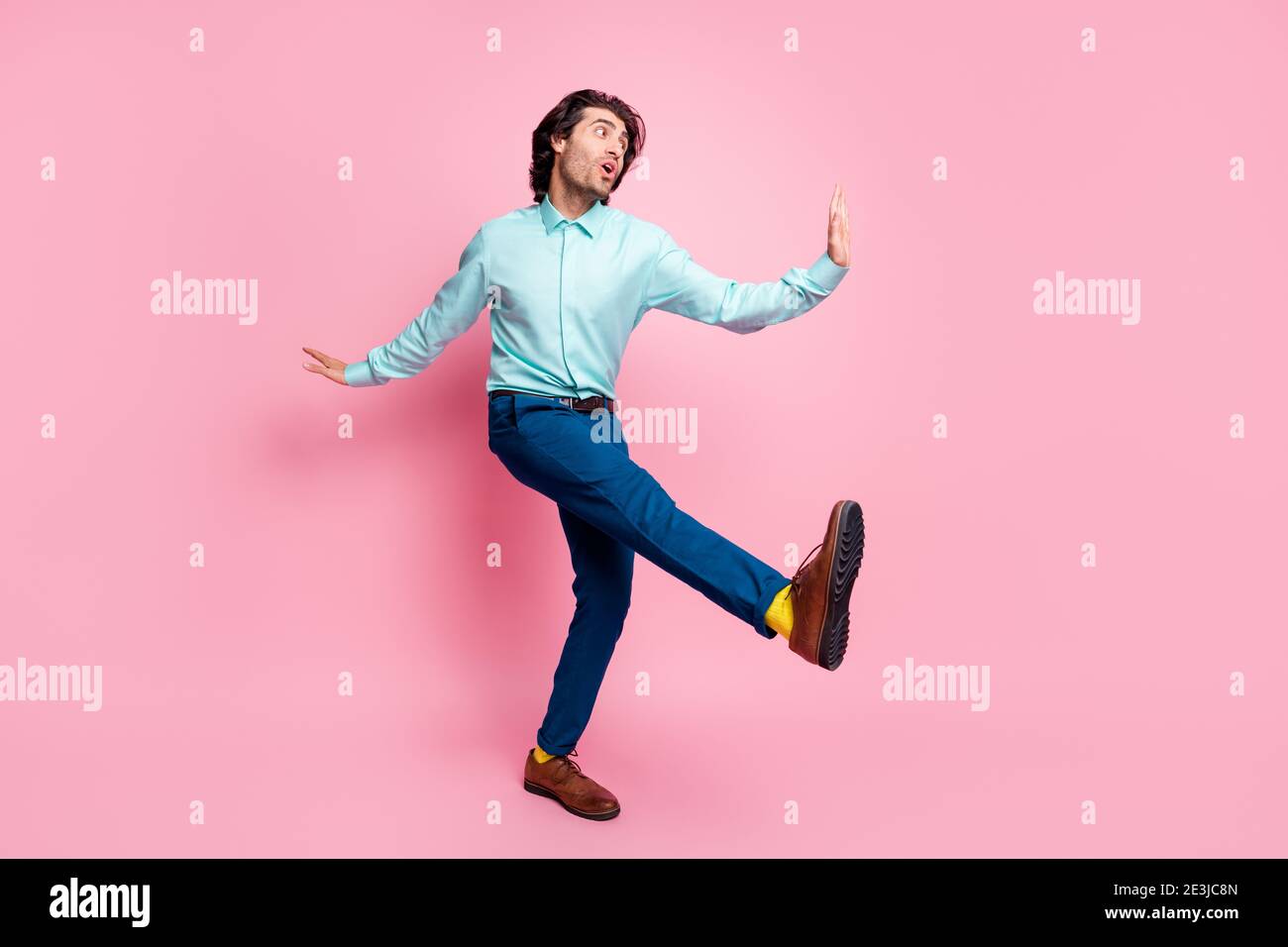Full body photo of young handsome man wear formalwear outfit yellow socks crazy hi greeting isolated over pink color background Stock Photo