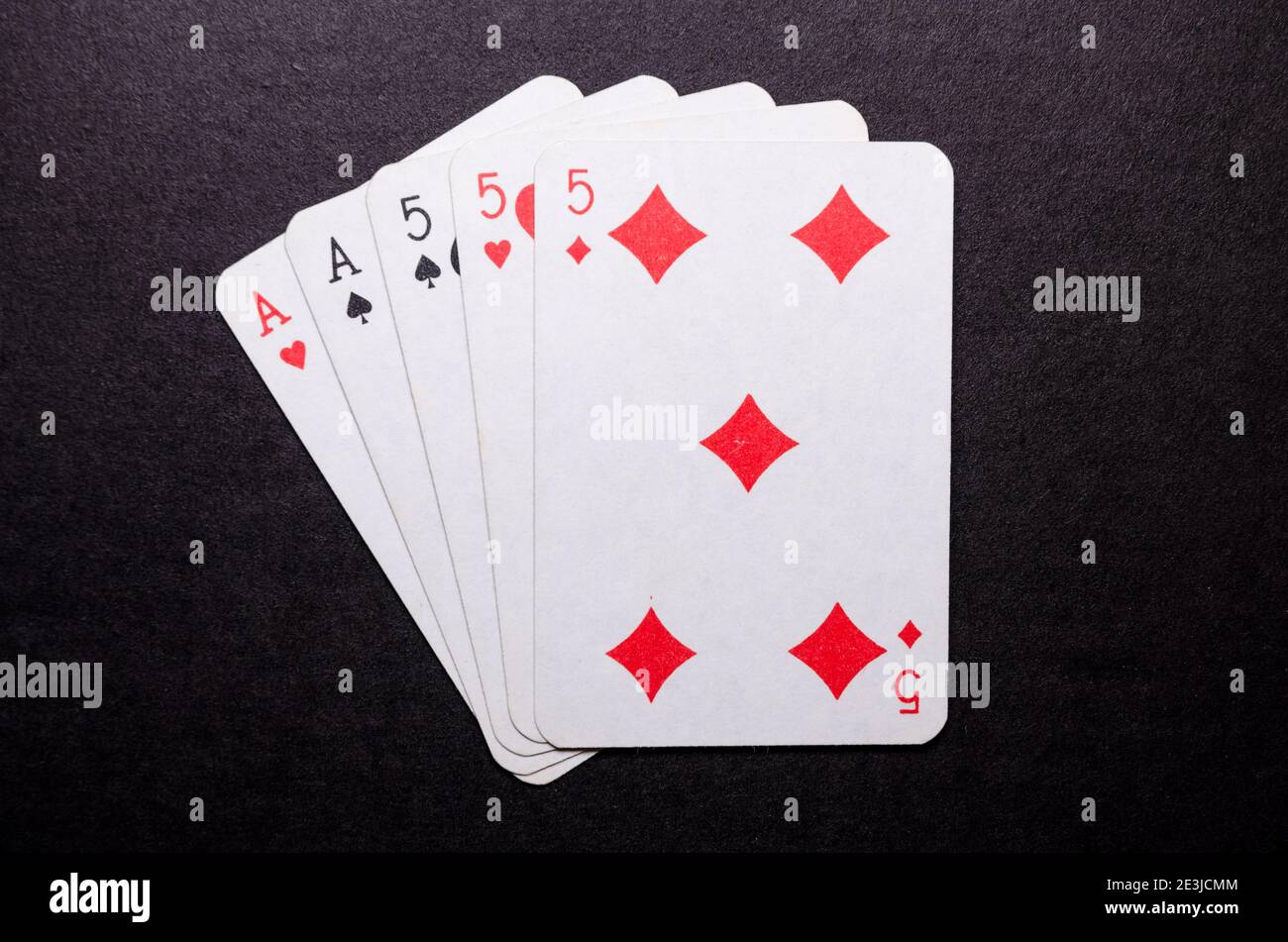 Playing cards on dark, black background, poker game hand, full house,  gambling concept, flat lay, view from directly above, top view Stock Photo  - Alamy