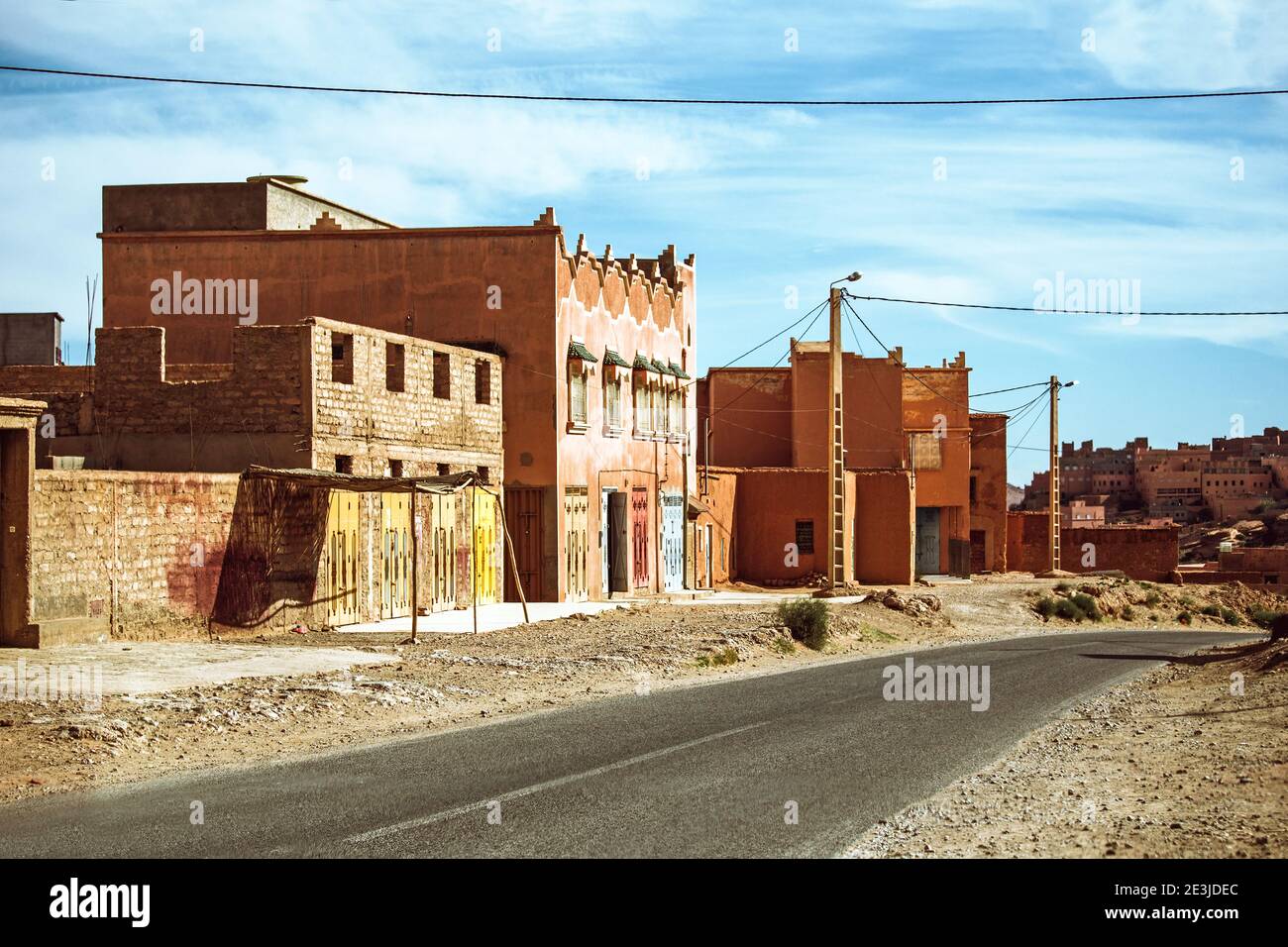 Street photo of an empty road with traditional moroccan houses in the