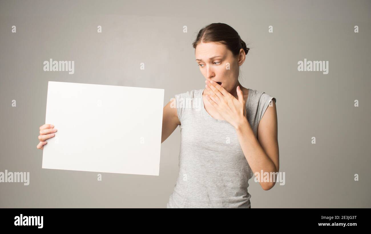 woman holding a sheet of paper in her hand Stock Photo