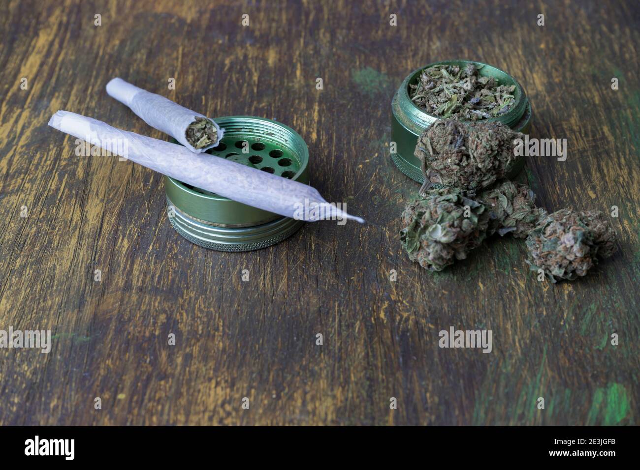 Buds of marijuana, grinder with crushed weed cannabis and rolled joints on  creative abstract wooden background.Medical and medicine , recreational ,we  Stock Photo - Alamy
