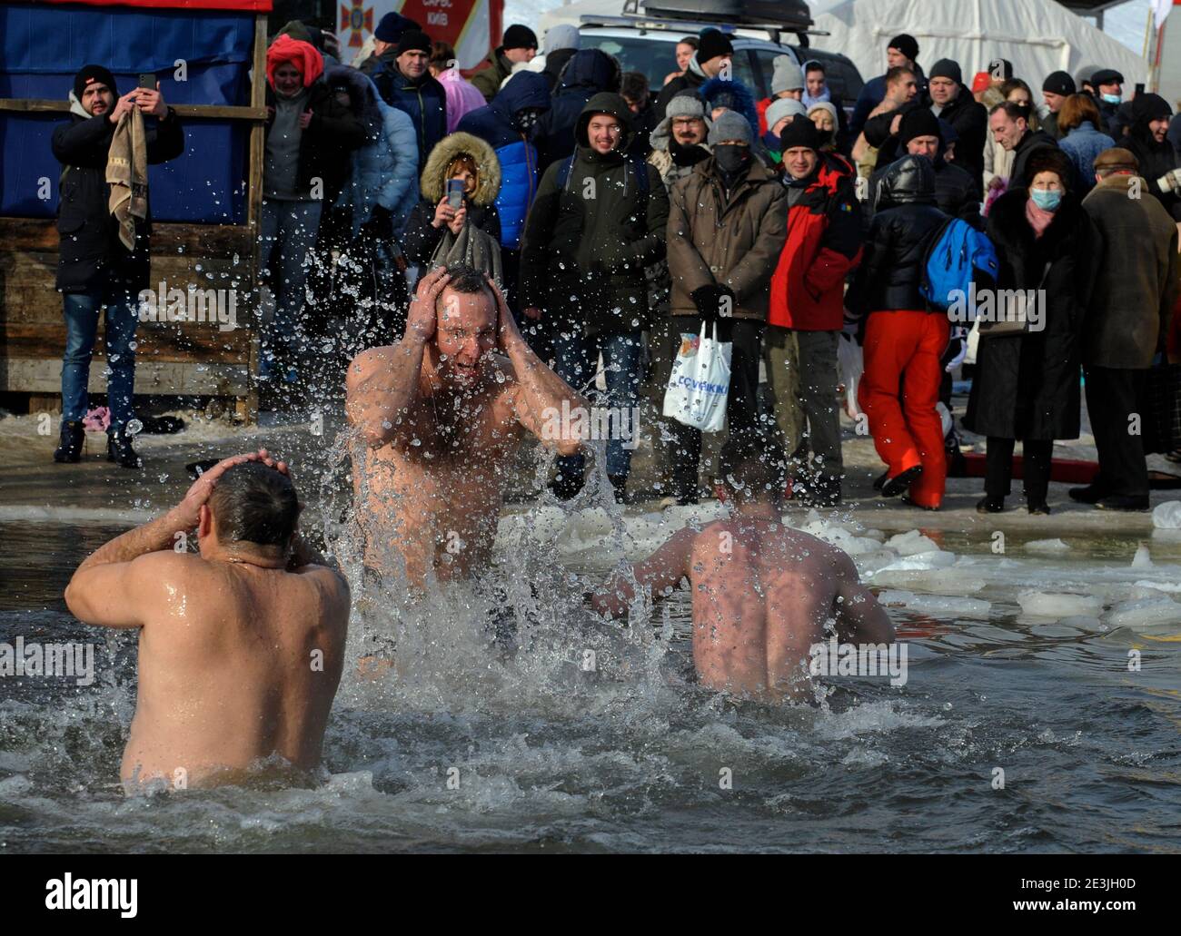 People seen plunging into icy water of the Dnieper river during the Orthodox Epiphany next to St. Pokrov's church.Epiphany, also known as Theophany in the east, is a Christian feast day that celebrates the revelation of God incarnate as Jesus Christ. In Western Christianity, the feast commemorates principally the visit of the Magi to the Christ Child, and thus Jesus' physical manifestation to the Gentiles. Stock Photo