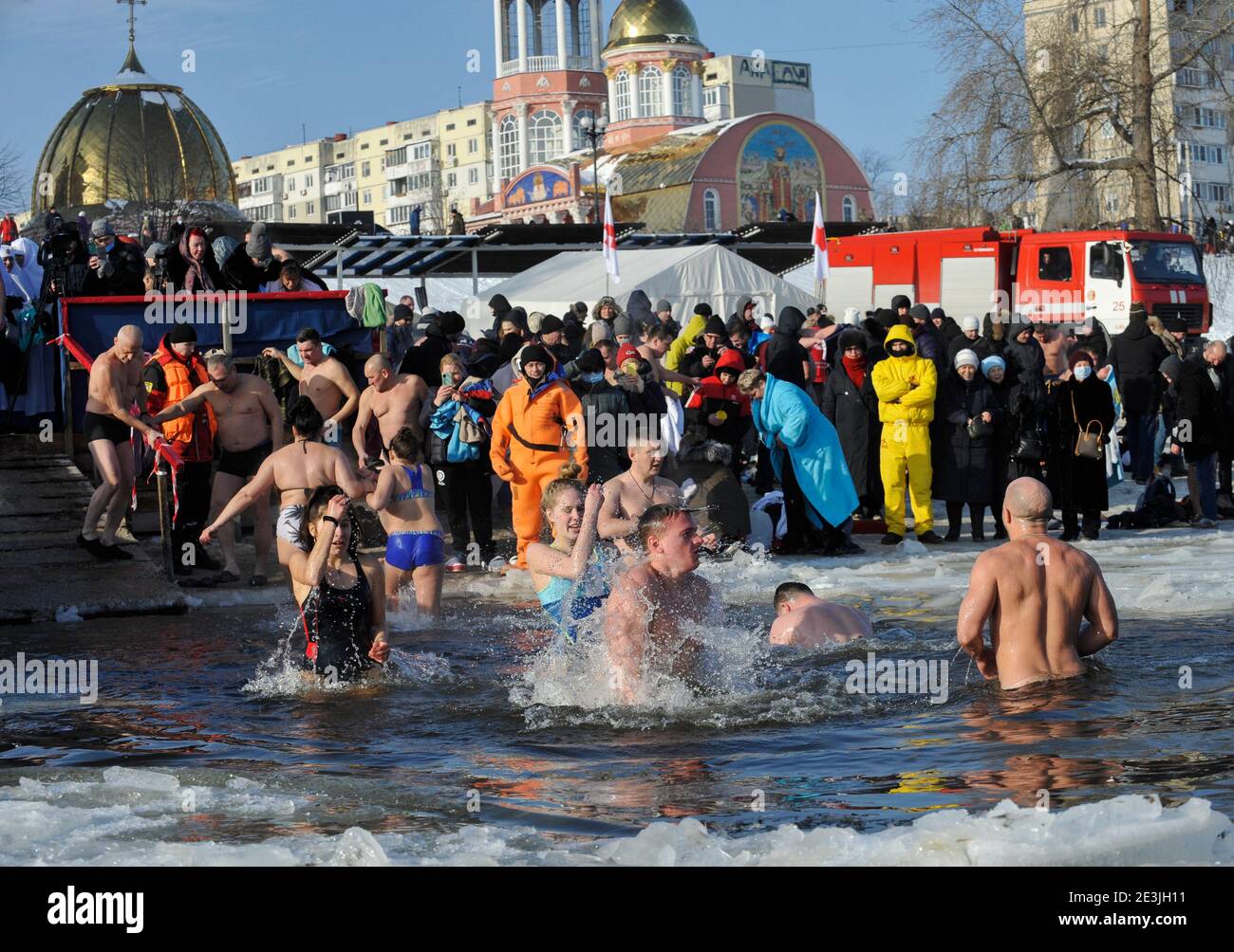 People seen plunging into icy water of the Dnieper river during the Orthodox Epiphany next to St. Pokrov's church.Epiphany, also known as Theophany in the east, is a Christian feast day that celebrates the revelation of God incarnate as Jesus Christ. In Western Christianity, the feast commemorates principally the visit of the Magi to the Christ Child, and thus Jesus' physical manifestation to the Gentiles. Stock Photo