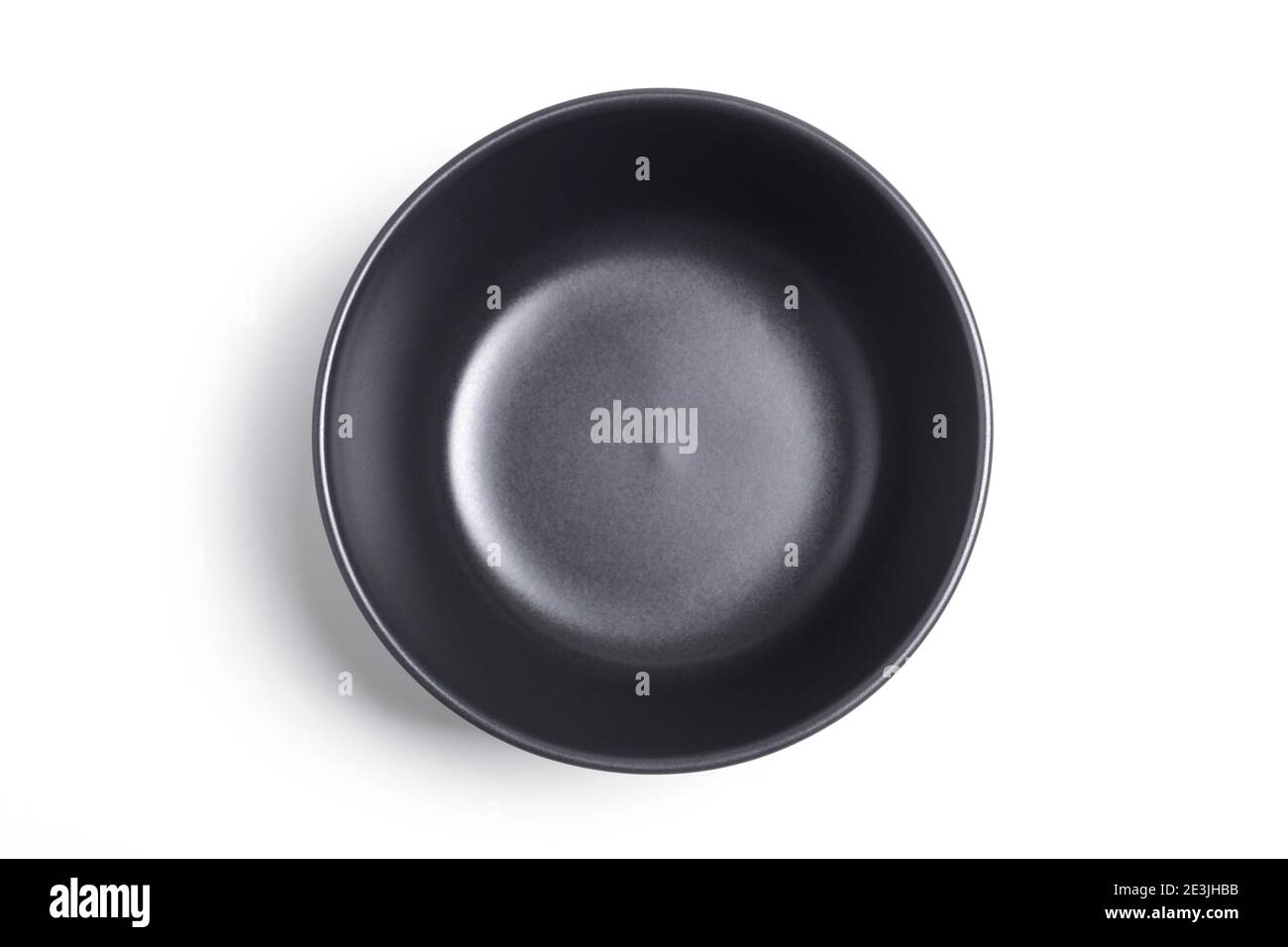 Black clay bowl isolated on white background. View from above Stock