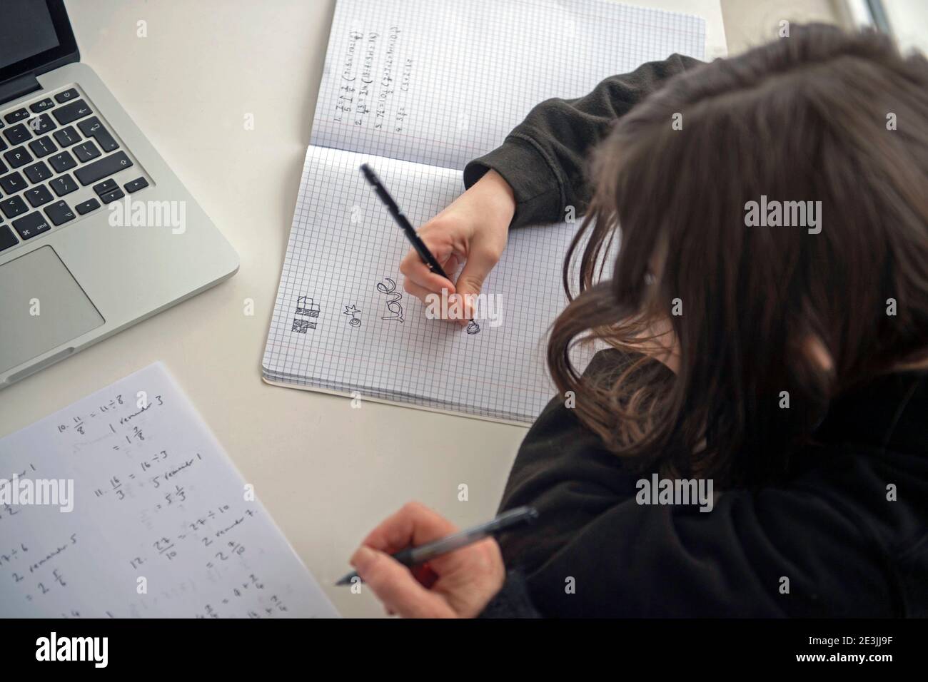 A child being home schooled with the help of a parent in the UK while both secondary and primary schools across the UK are still closed to the current Stock Photo