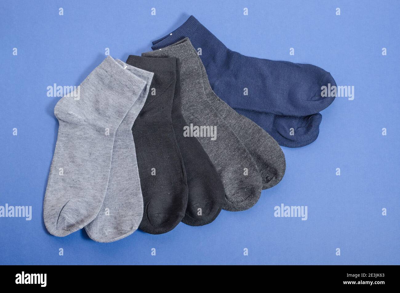 Classic mens multicolored socks on a blue background, mens clothing. Stock Photo