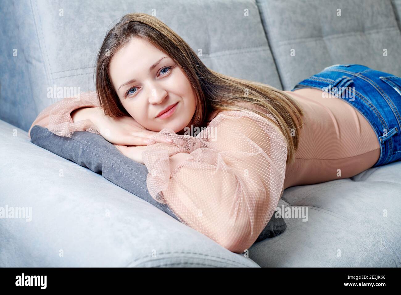 portraits of a girl lying on the sofa relaxed Stock Photo - Alamy