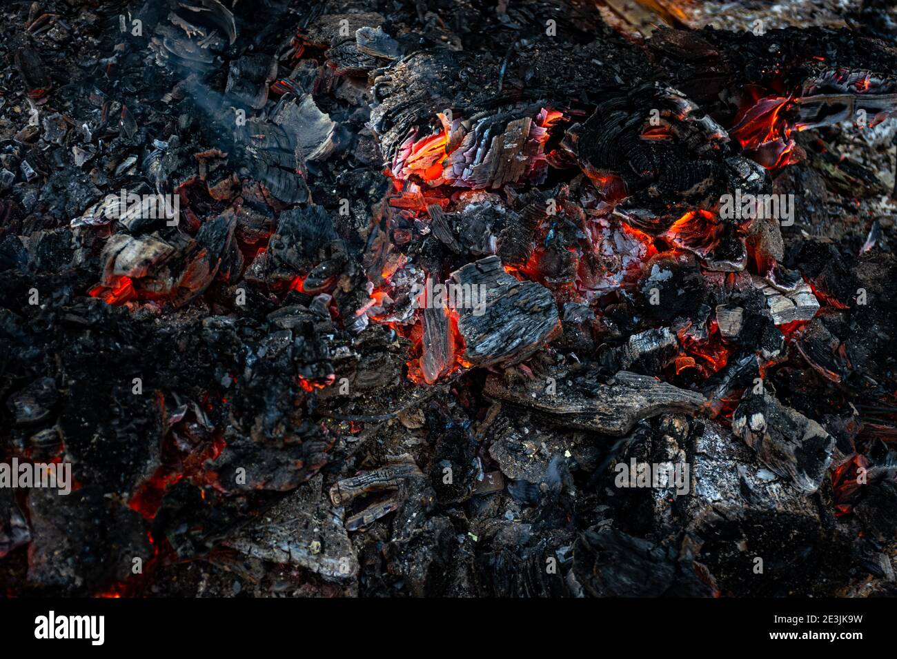 Burning coals at night, rotting coal, barbecue season. Close-up. Stock Photo