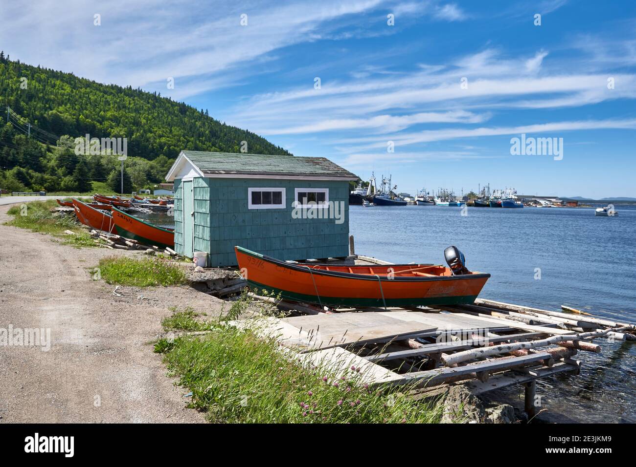 Small fisherman's hut with boats on coastal shore in Newfoundland Stock Photo