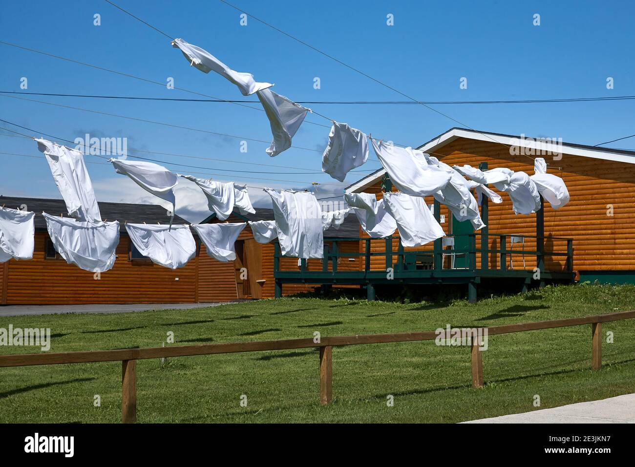 Washing drying in the wind by wood cabin in Newfoundland Stock Photo
