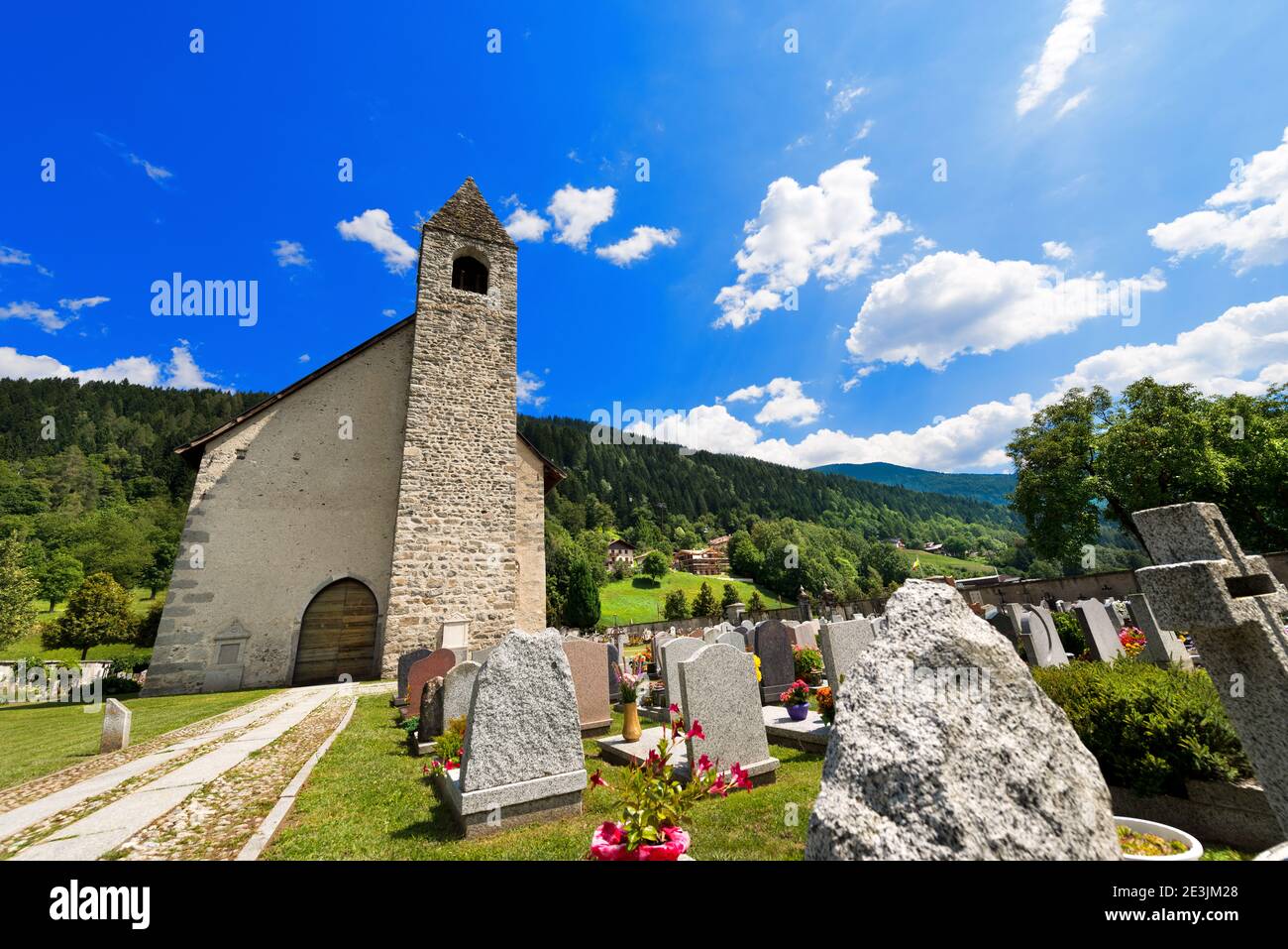 Ancient mountain church of San Vigilio (1515) with cemetery in Pinzolo, Trento Italy Stock Photo