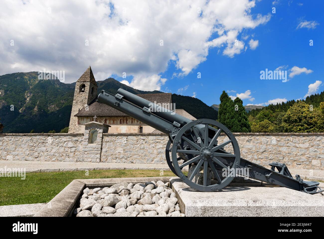 Pinzolo, Italy - August 5th, 2015: Ancient church of San Vigilio (1515) and the war cannon in Pinzolo, Trentino Alto Adige, Italy Stock Photo