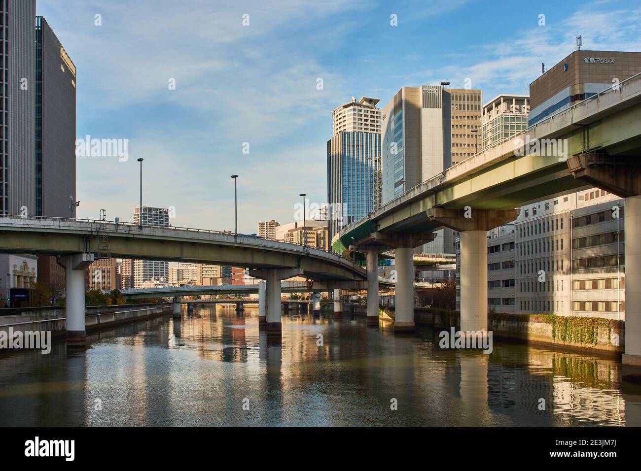Osaka, Japan - November 25, 2017: Osaka downtown business area and bridges across Okawa river in Osaka, Japan Stock Photo