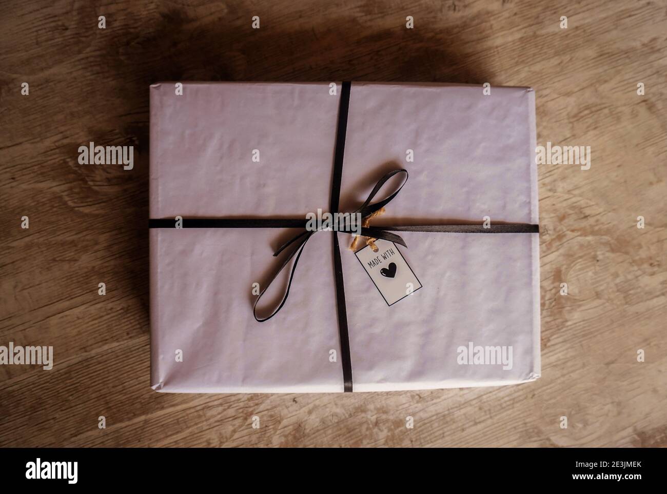 gift box with tag on wooden background Stock Photo