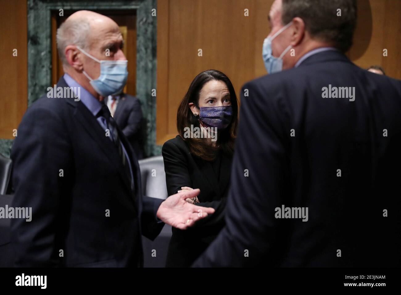 Avril Haines (C) stands with Dan Coats (L), former Director of National  Intelligence, and Senator Mark Warner (D-VA), incoming-Senate Intelligence  Committee Chairman, before the start of the Senate Intelligence Committee  confirmation hearing