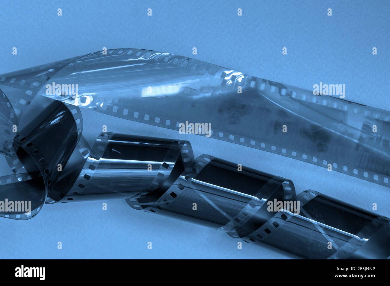 Negatives of old black and white photographic films, filmstrip on blue background. Photo, movie, cinema concept Stock Photo