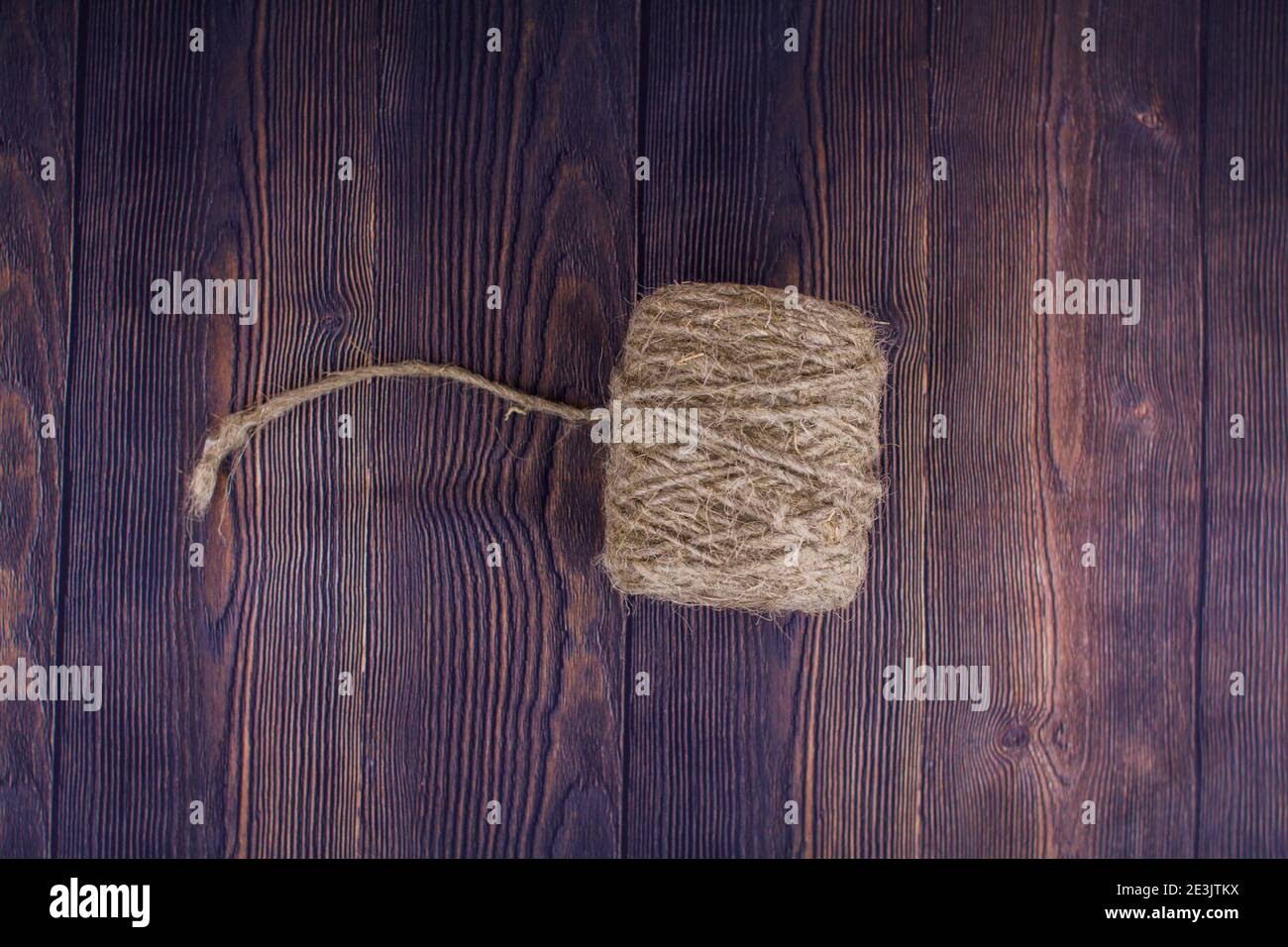 a dark craft thread on wooden background Stock Photo
