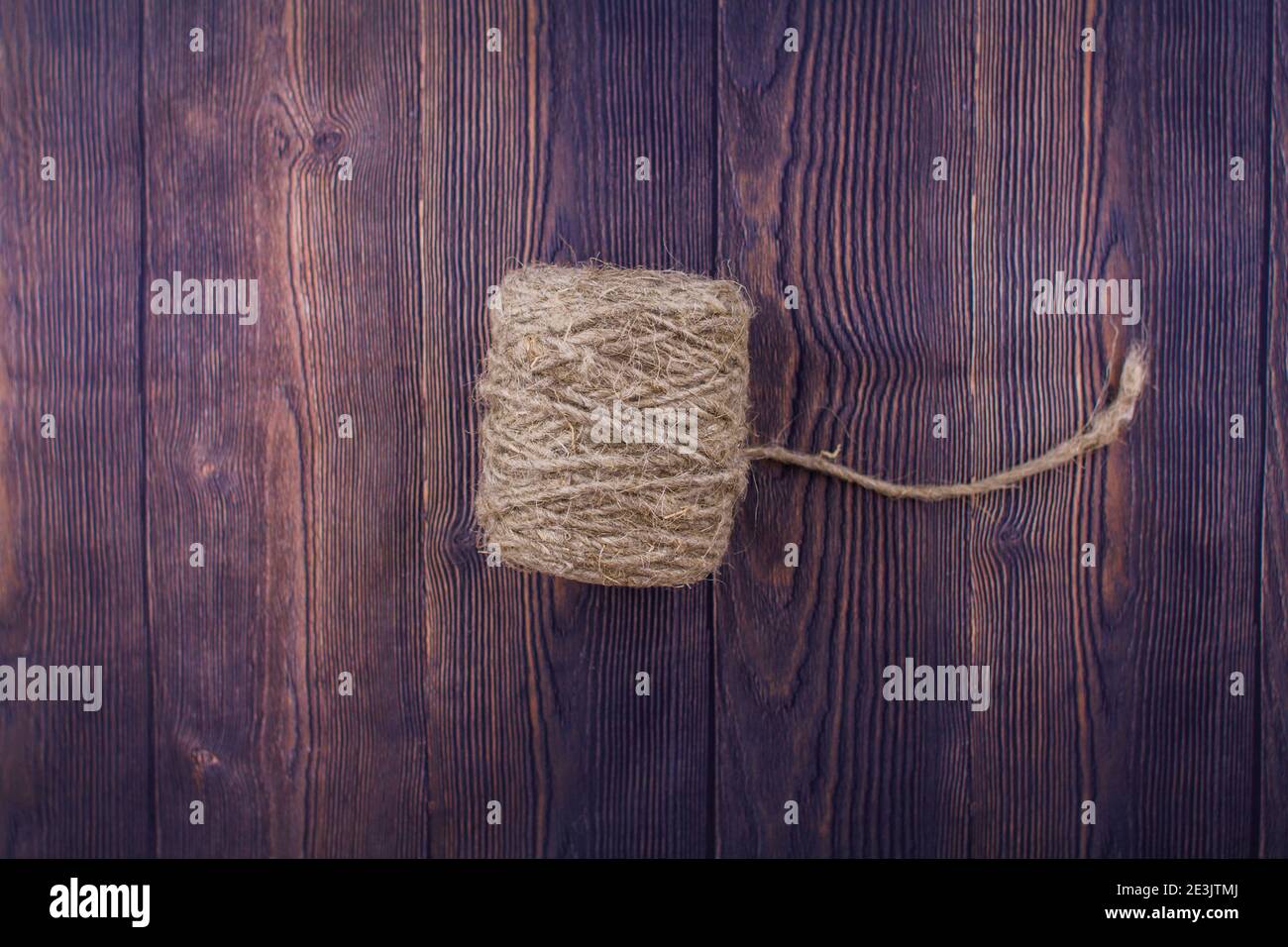 a dark craft thread on wooden background Stock Photo