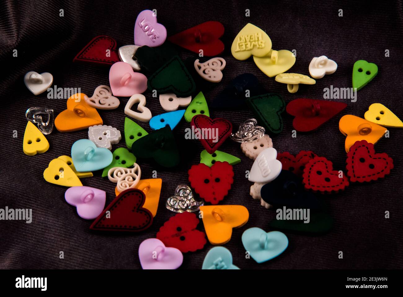 Heart shaped buttons on a black background. Stock Photo
