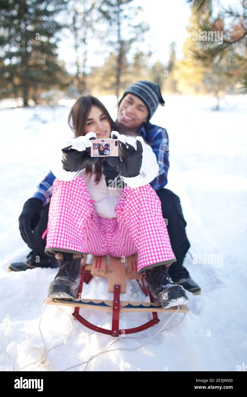Couple taking selfie in snowy forest Stock Photo