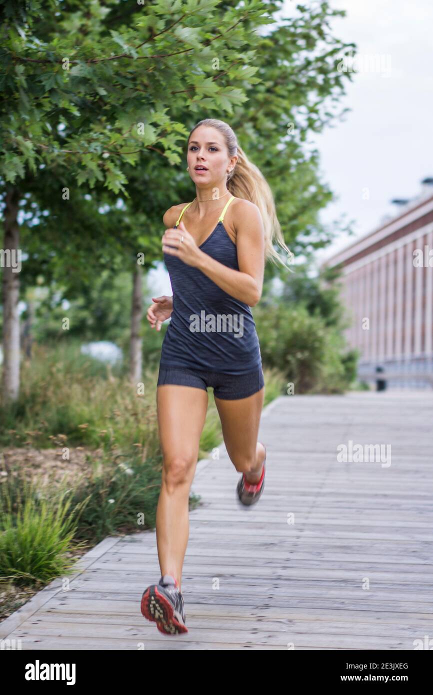 Blonde female working out on urban boardwalk, Montreal, Quebec, Canada Stock Photo