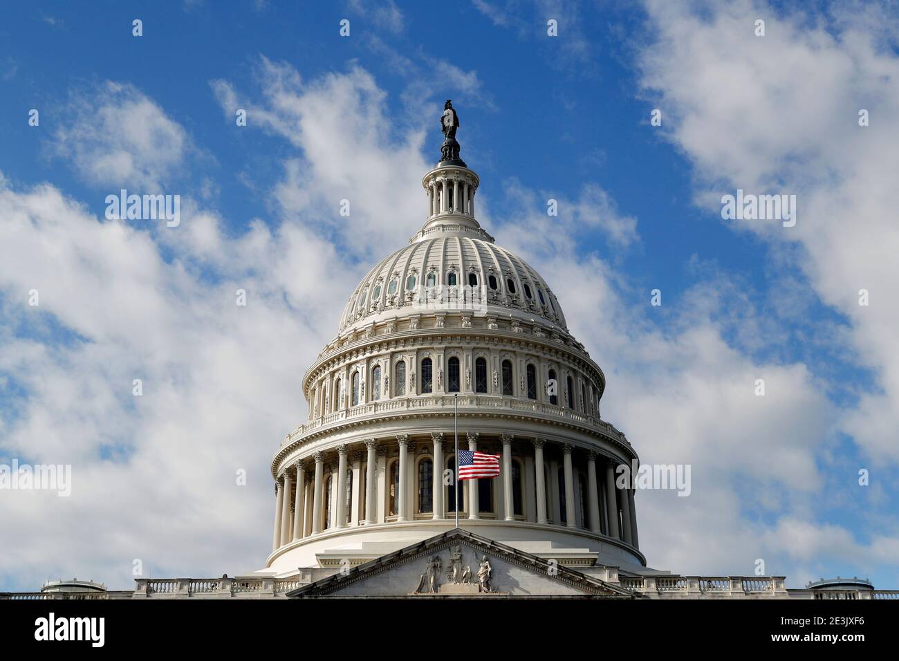 A U.S. flag flies at half-mast for a police officer who died following the Capitol riots in Washington, U.S. January 19, 2021. REUTERS/Mike Segar Stock Photo