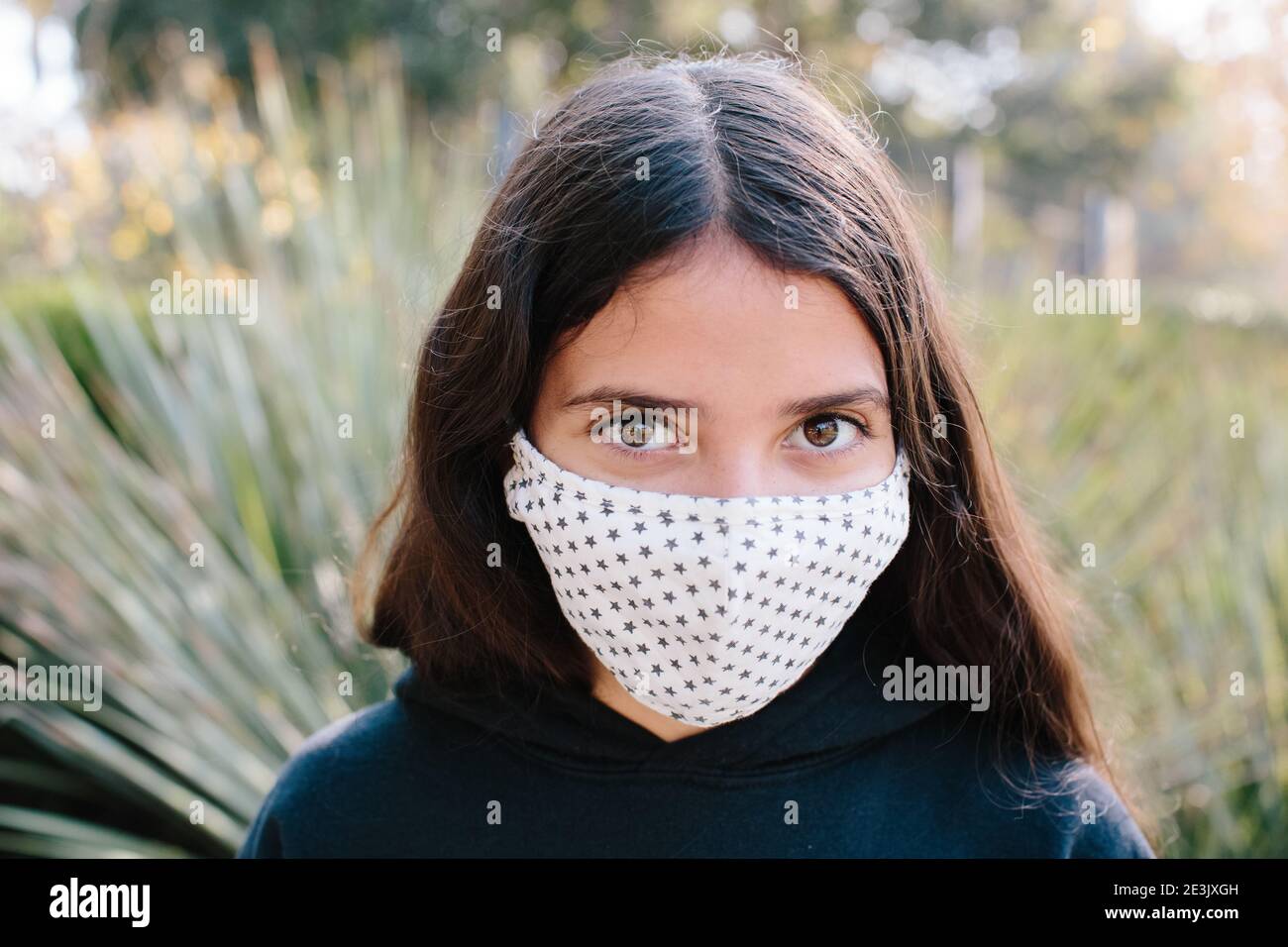 Tween Girl Looking At Camera While Wearing A Cloth Face Mask Stock ...