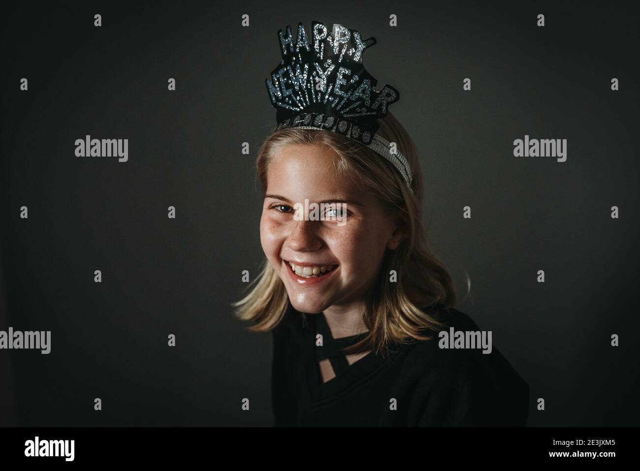 Portrait of young girl with Happy New Year hat smiling Stock Photo