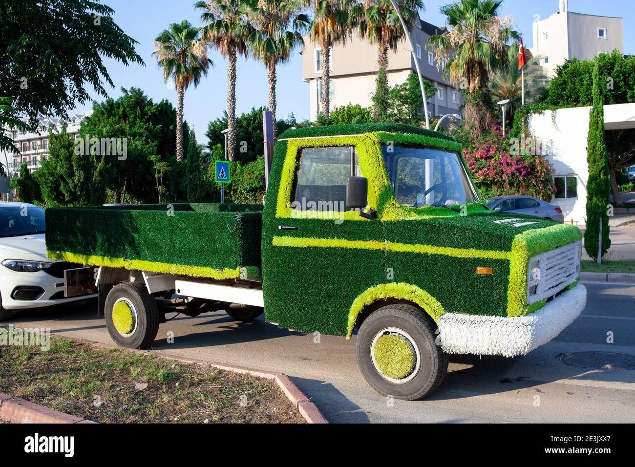 truck car decorated artificial green grass. Concept of energy saving
