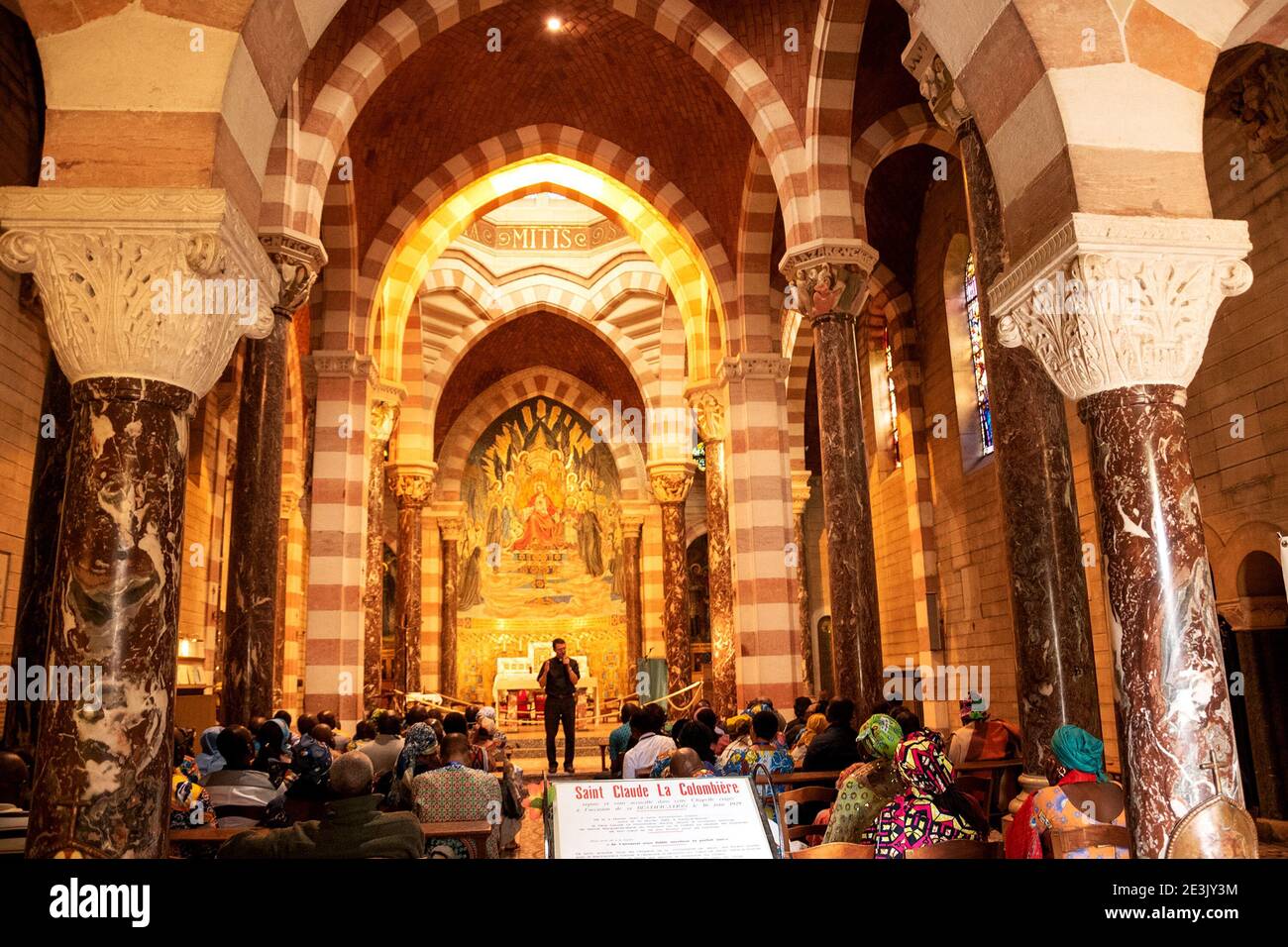PARAY-LE-MONIAL, FRANCE - AUGUST 25, 2018: African pilgrims in Chapel of St. Claude de la Colombiere (who was canonized by Pope John Paul II in 1992) Stock Photo