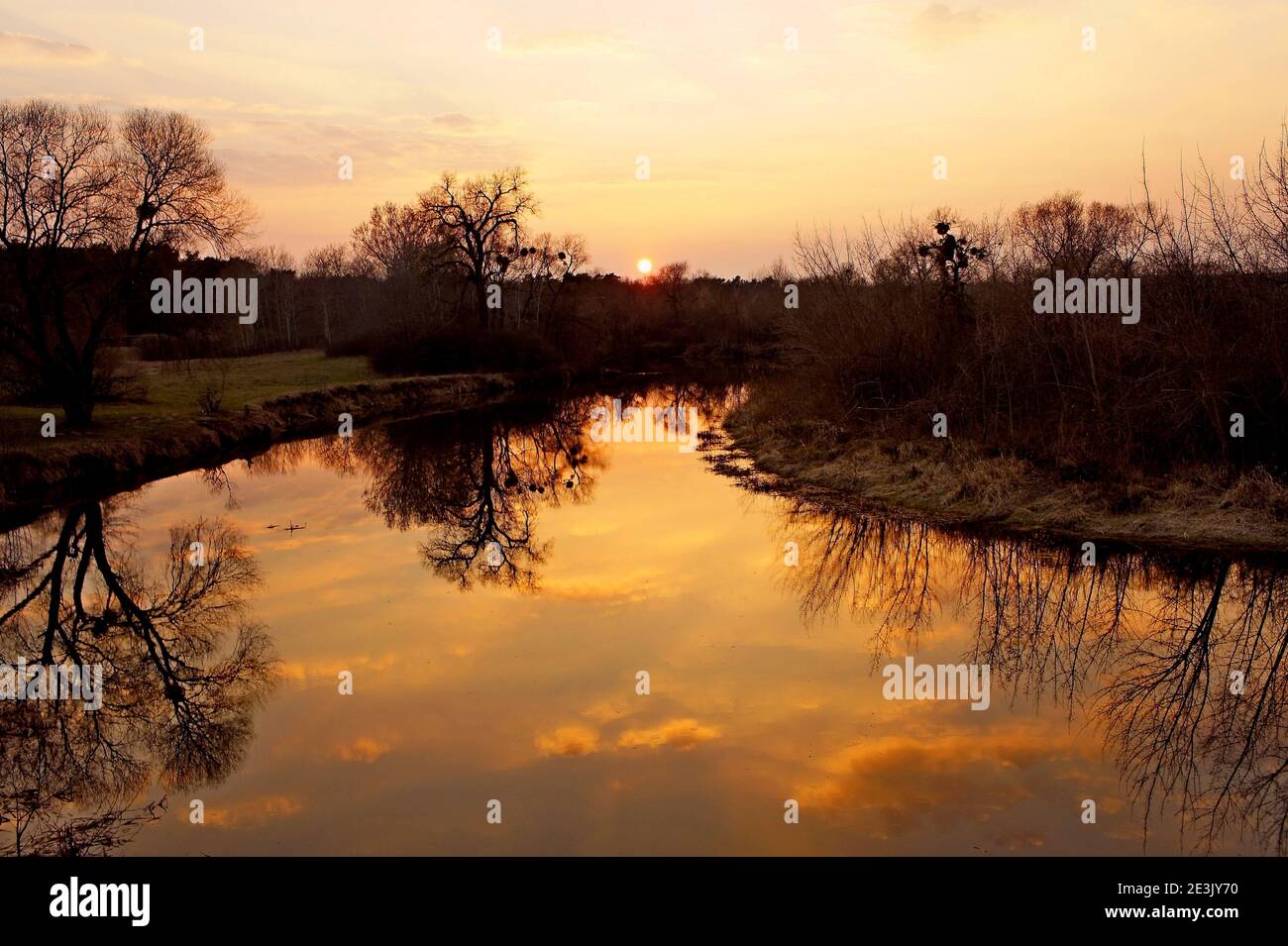 Atmospheric sunset with reflection in the water hi-res stock ...