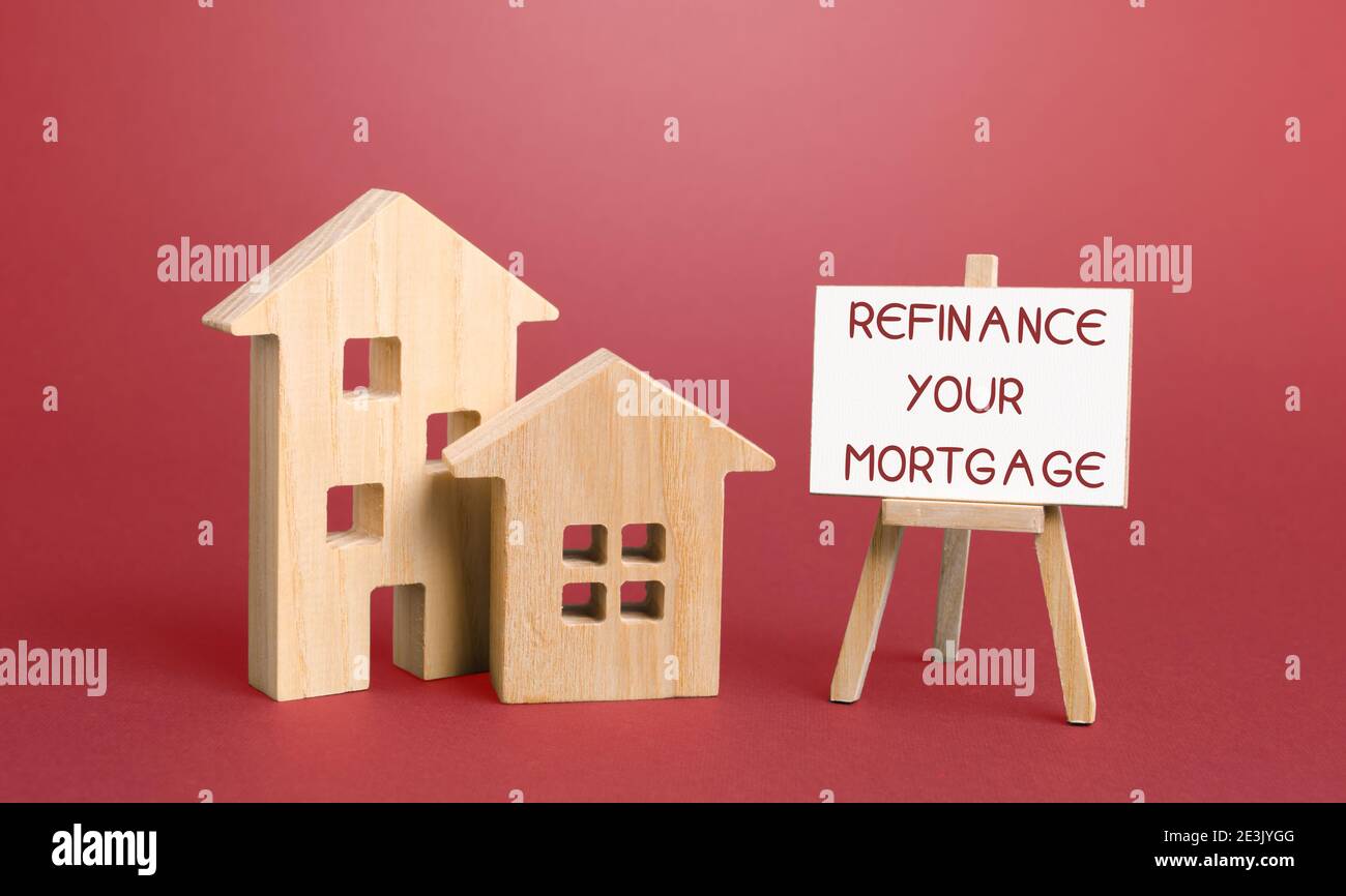 Inscription Refinance your mortgage and miniature houses. Real estate, finance and business concept. Interest rates. Property financing concept Stock Photo