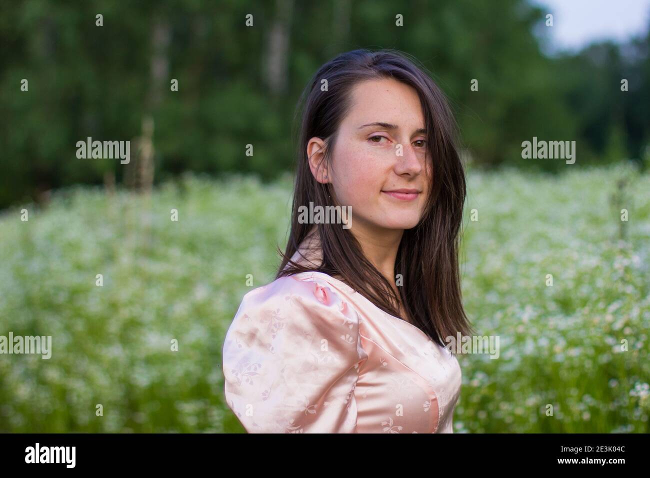 girl standing in the field in a pink dress Stock Photo - Alamy