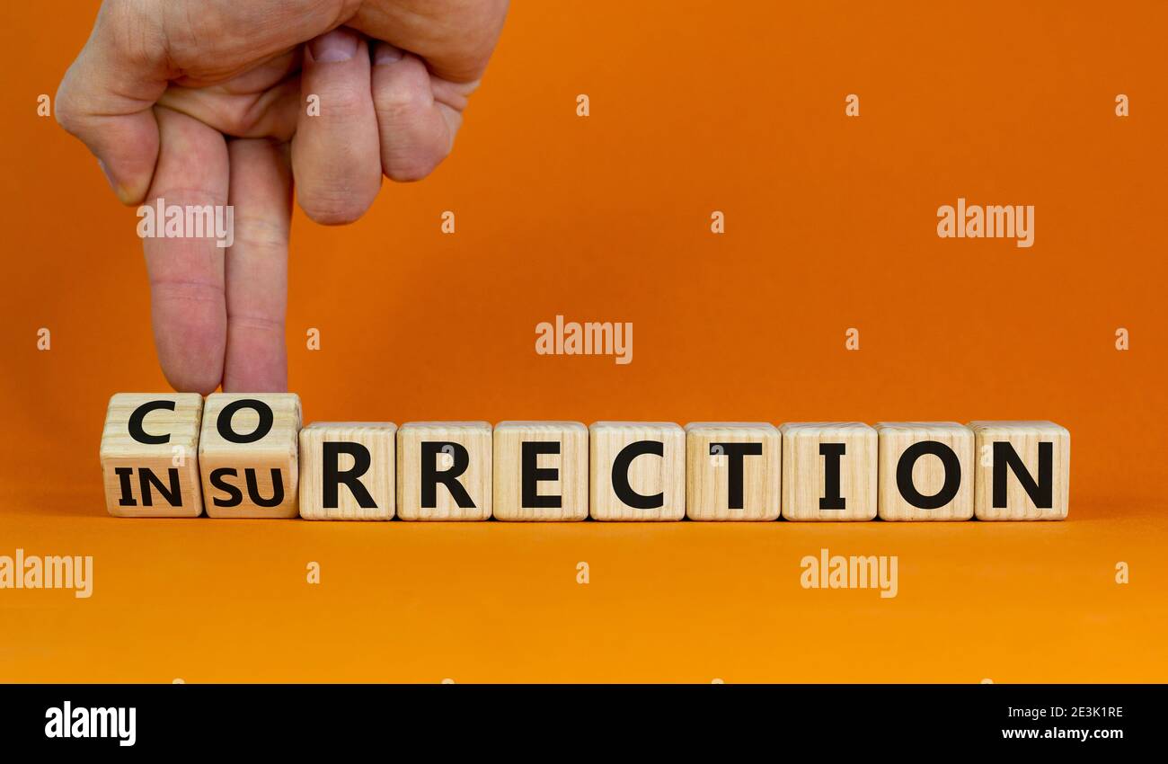 Correction vs insurrection symbol. Businessman turns wooden cubes and