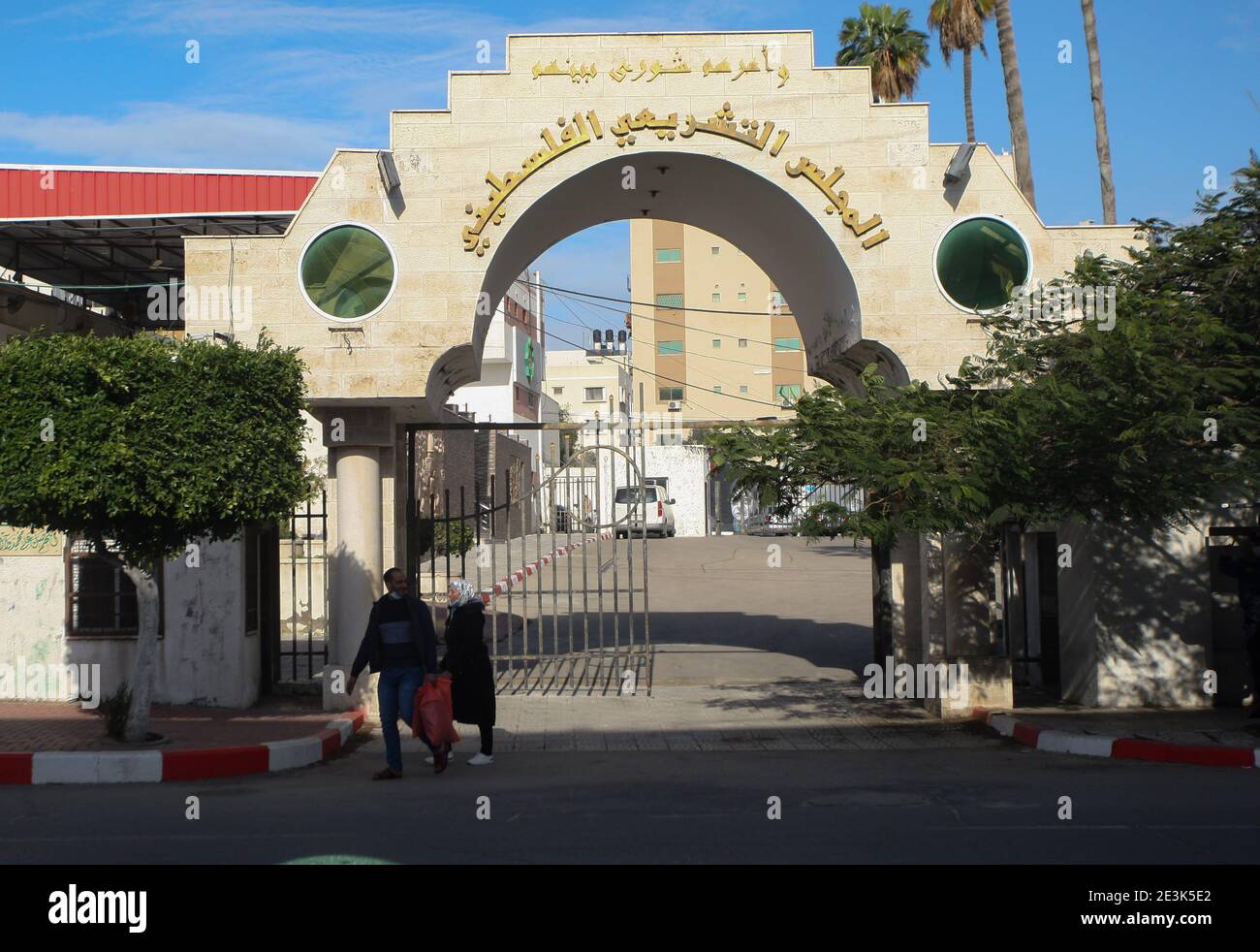 Palestinians walk past the entrance gate of the Legislative Council building in Gaza City on Tuesday on January 19, 2021. Palestinian president Mahmud Abbas on January 15, announced dates for the first elections in more than 15 years, setting legislative polls for May 22 and a July 31 presidential vote. Abbas's Fatah party, which controls the Palestinian Authority based in the occupied West Bank and the Hamas Islamists, who hold power in Gaza, have for years expressed interest in taking Palestinians back to the polls. Photo by Ismael Mohamad/UPI Stock Photo