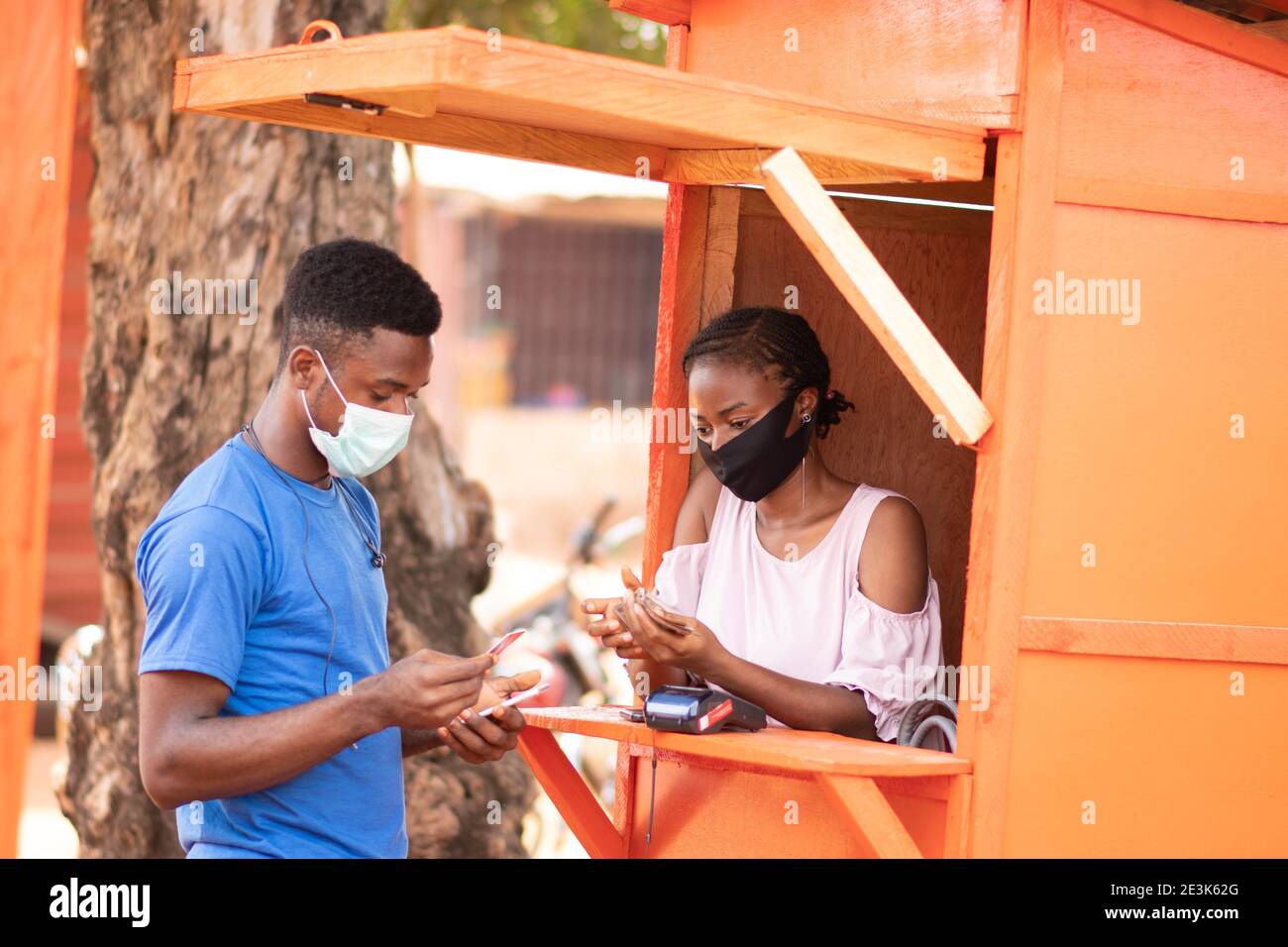 nigerian man at a roadside pos service kiosk to withdraw cash Stock Photo