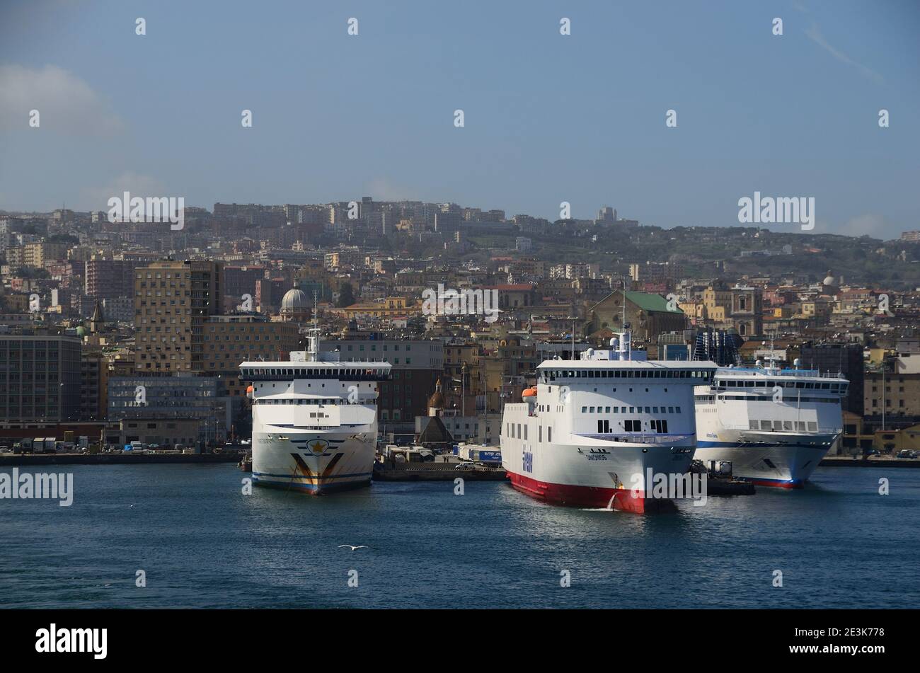 large ships and many homes in the port of Naples Italy Stock Photo