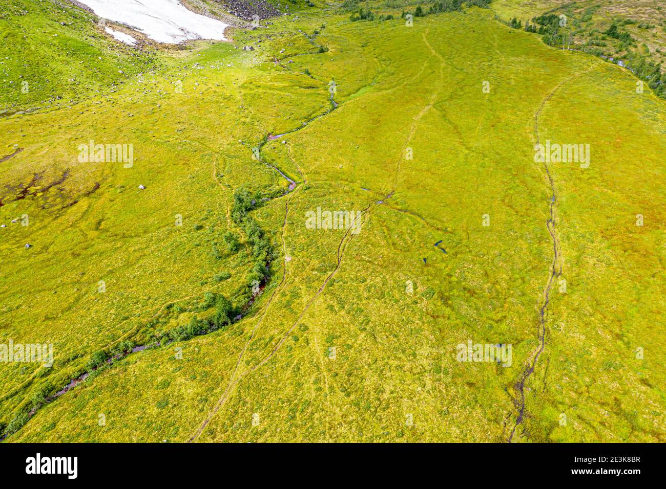 Aerial view of valley Langedalen, hiking path, stream meanders through green landscape, Sognefjord region, Norway. Stock Photo