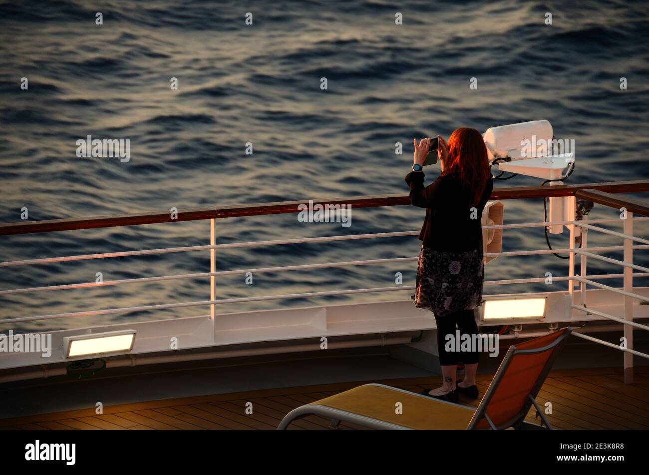 woman photographing sunset on a ship at sea Stock Photo - Alamy