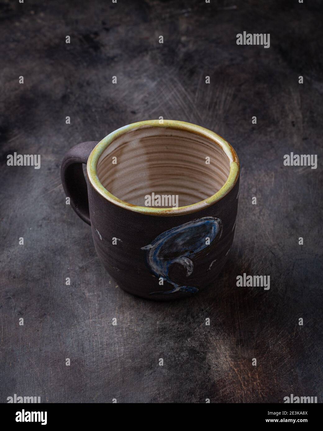 Handmade ceramic cup on dark stone backgroud, copy space. Stock Photo