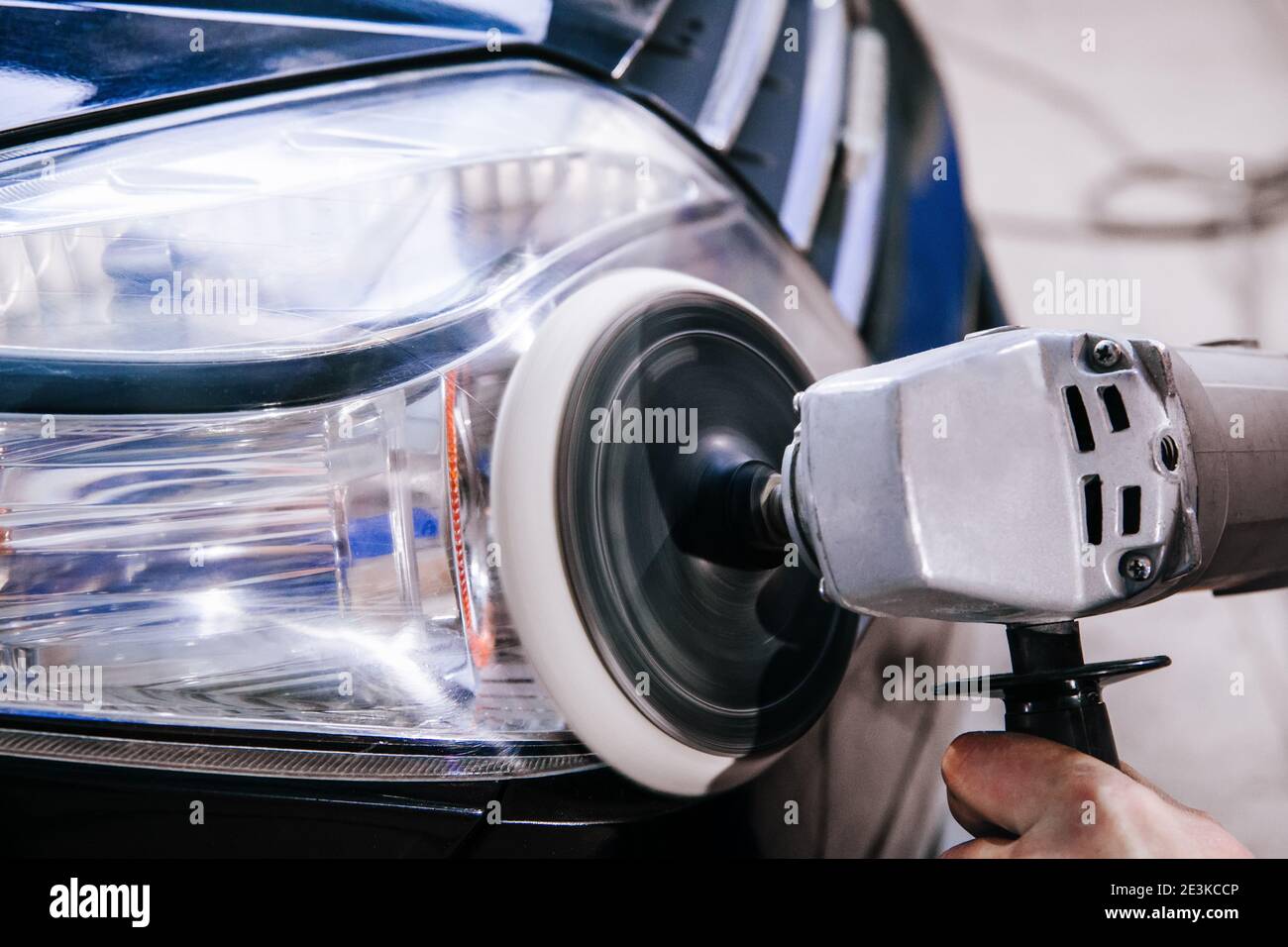 Car headlight cleaning polishing machine at car service at shallow depth of field Stock Photo