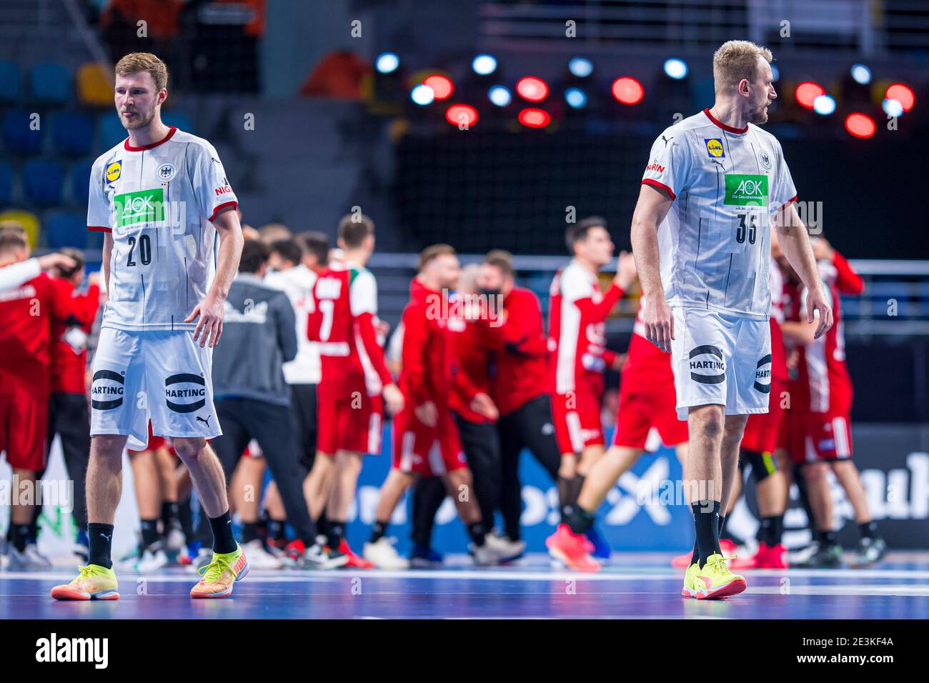 Madinat Sittah Uktubar, Egypt. 19th Jan, 2021. Handball: World Cup, Germany - Hungary, Preliminary Round, Group A, Matchday 3. Germany's Philipp Weber (l) and Julius Kühn (r) turn away disappointed while the Hungarian team celebrates. Credit: Sascha Klahn/dpa/Alamy Live News Stock Photo
