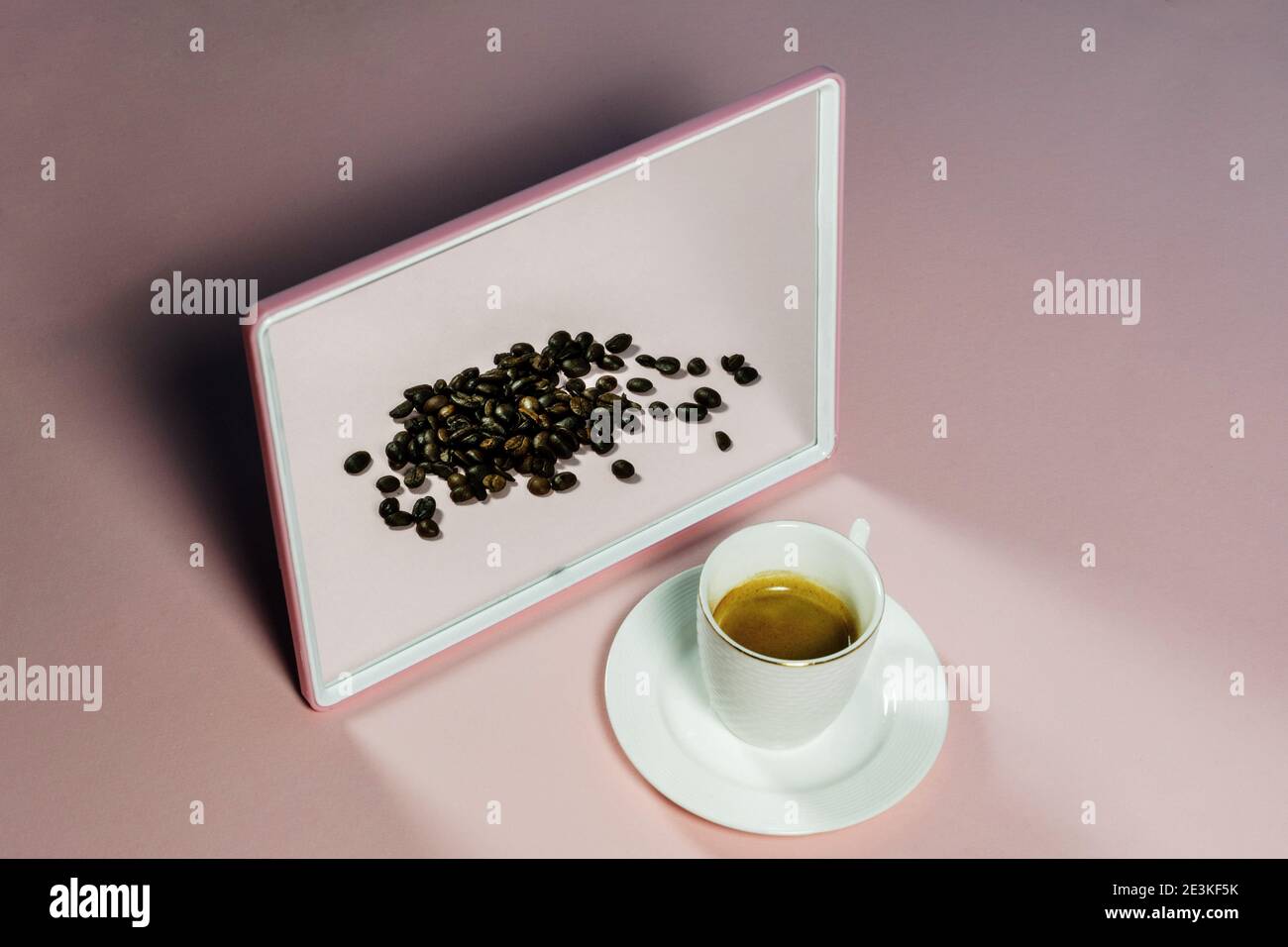 Espresso coffee in a mirror with coffee beans in reflection. Creative coffee concept Stock Photo