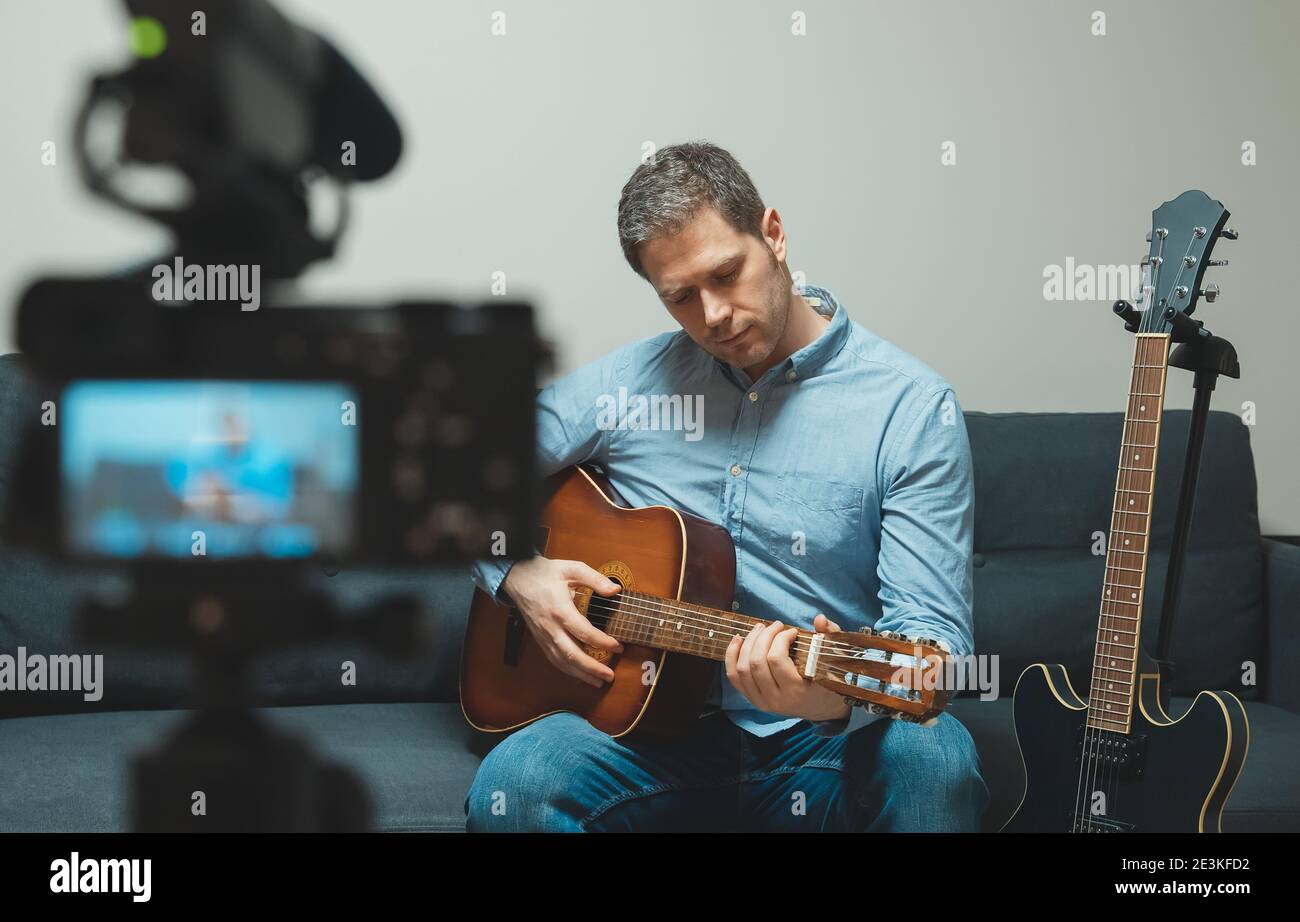 Man with spanish guitar in front of the video camera. Stock Photo
