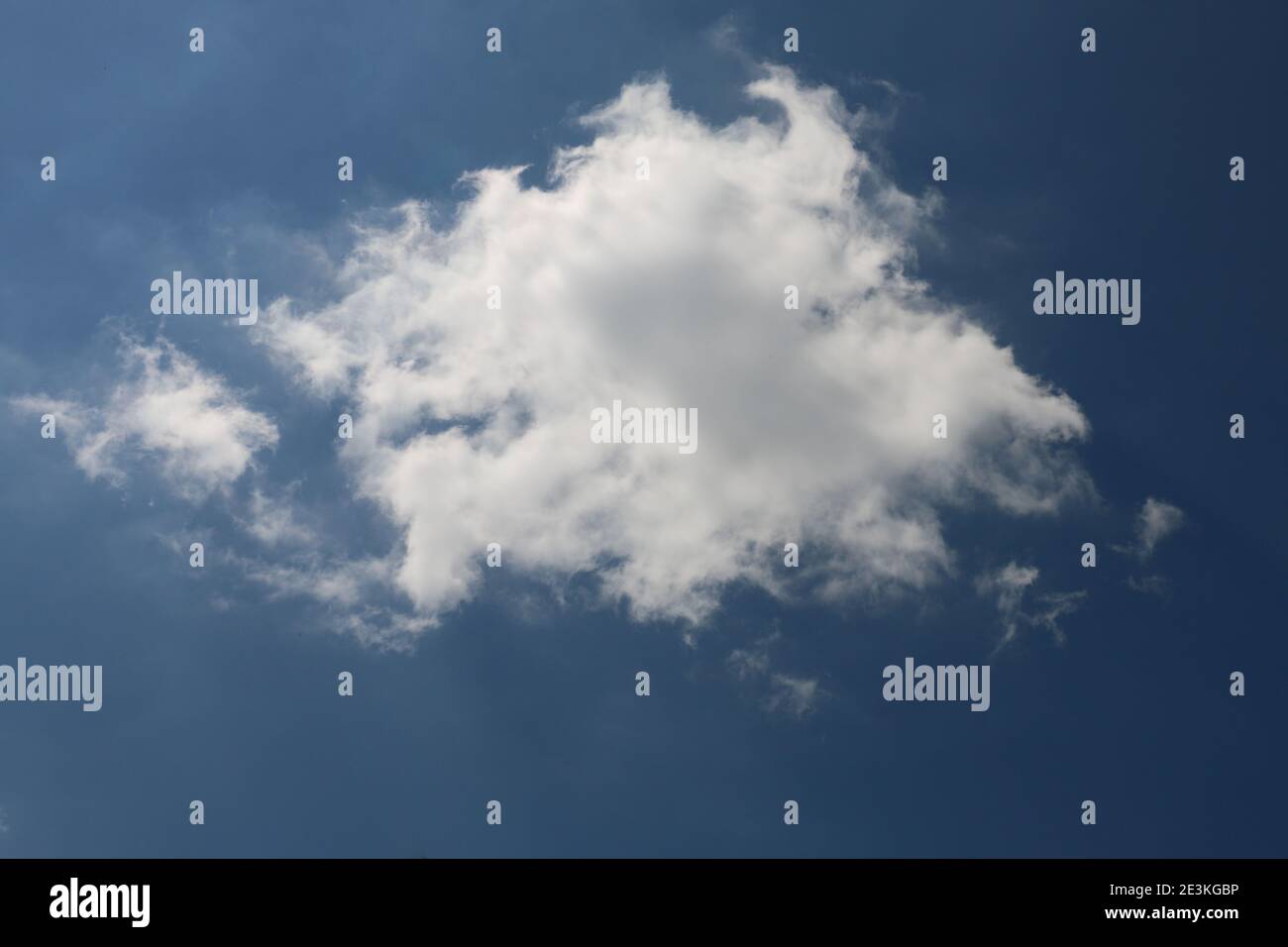 Fluffy white cumulus cloud in a blue summer sky Stock Photo