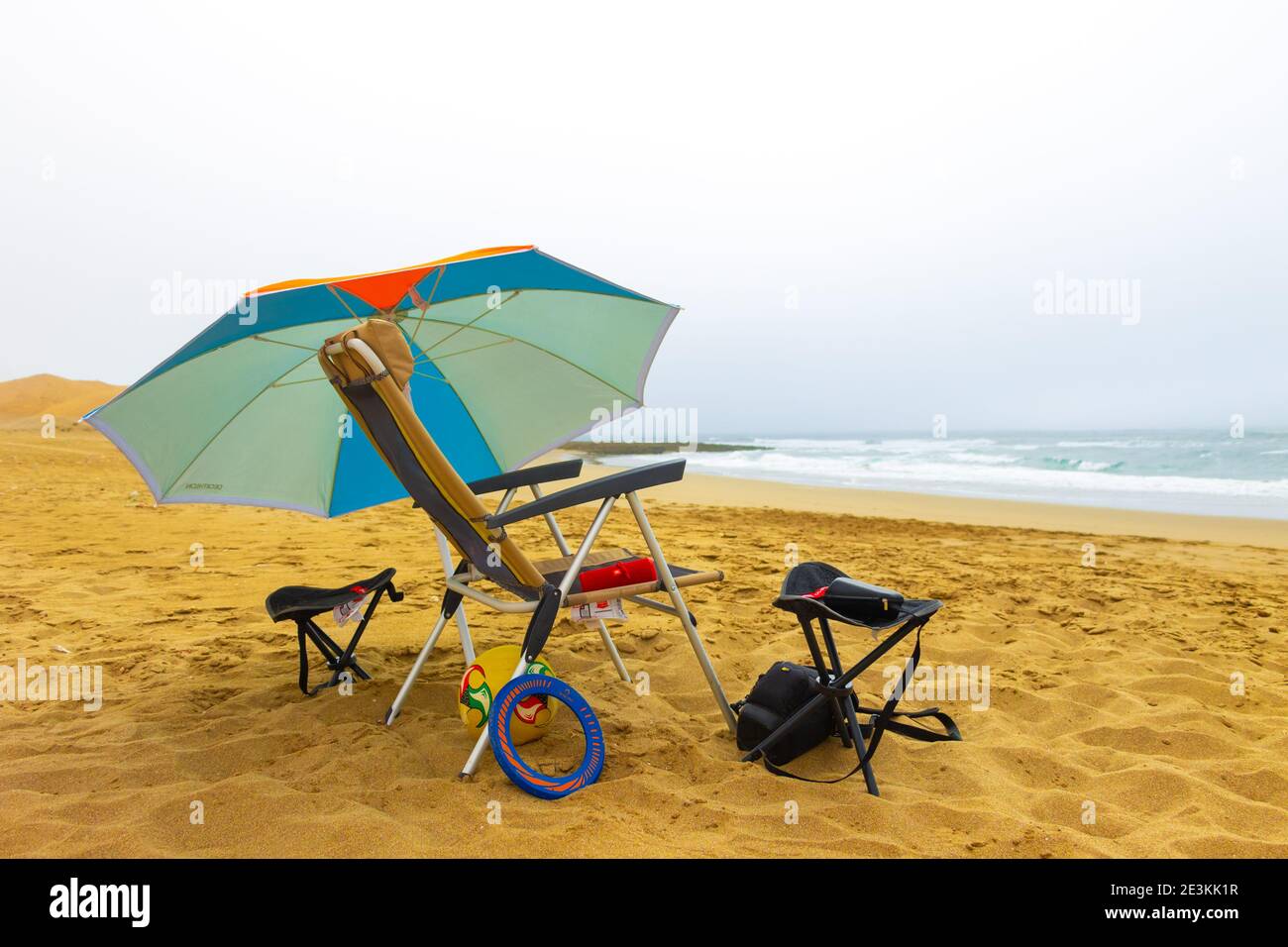 Beach Decathlon umbrella, Quechua chairs, a freesbe and a JBL Flip 4 Hight  speaker Stock Photo - Alamy