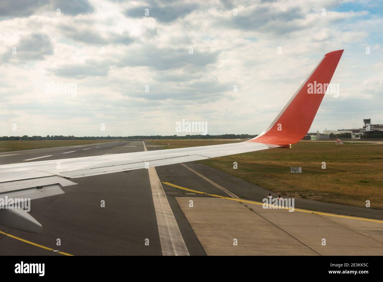 Aircraft heading to the runway take off possition. Airplane wing and take-off runway window view from the jet airliner passenger cabin. Travel concept Stock Photo